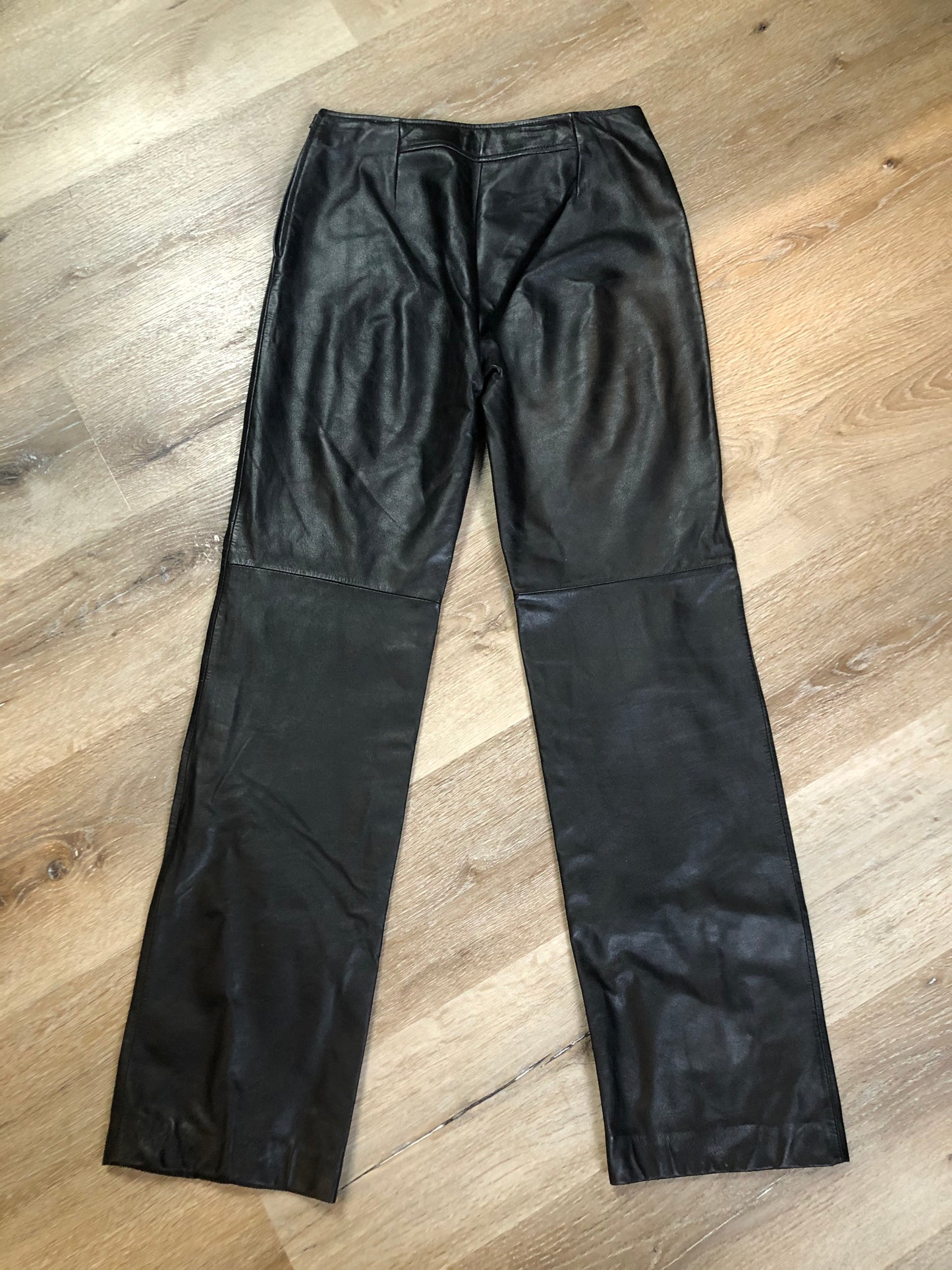 Danier black leather straight leg pants with side zip closure, partially lined. Size 4 Canadian (28x31).