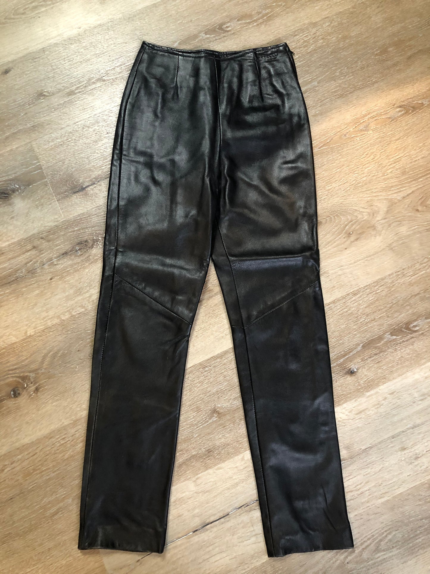 Danier black leather tapered leg pants with size zip closure, partially lined. Made in Canada. Size 2 (24x28).