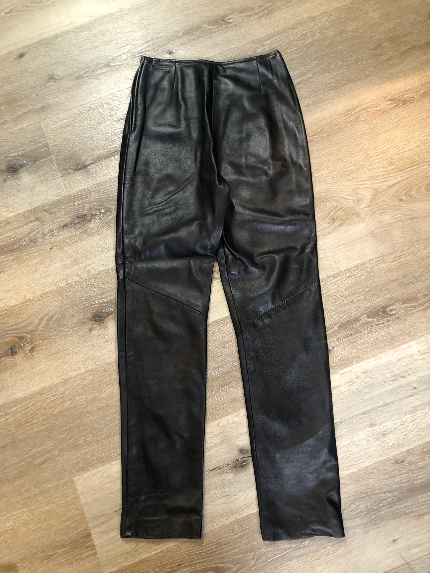 Danier black leather tapered leg pants with size zip closure, partially lined. Made in Canada. Size 2 (24x28).