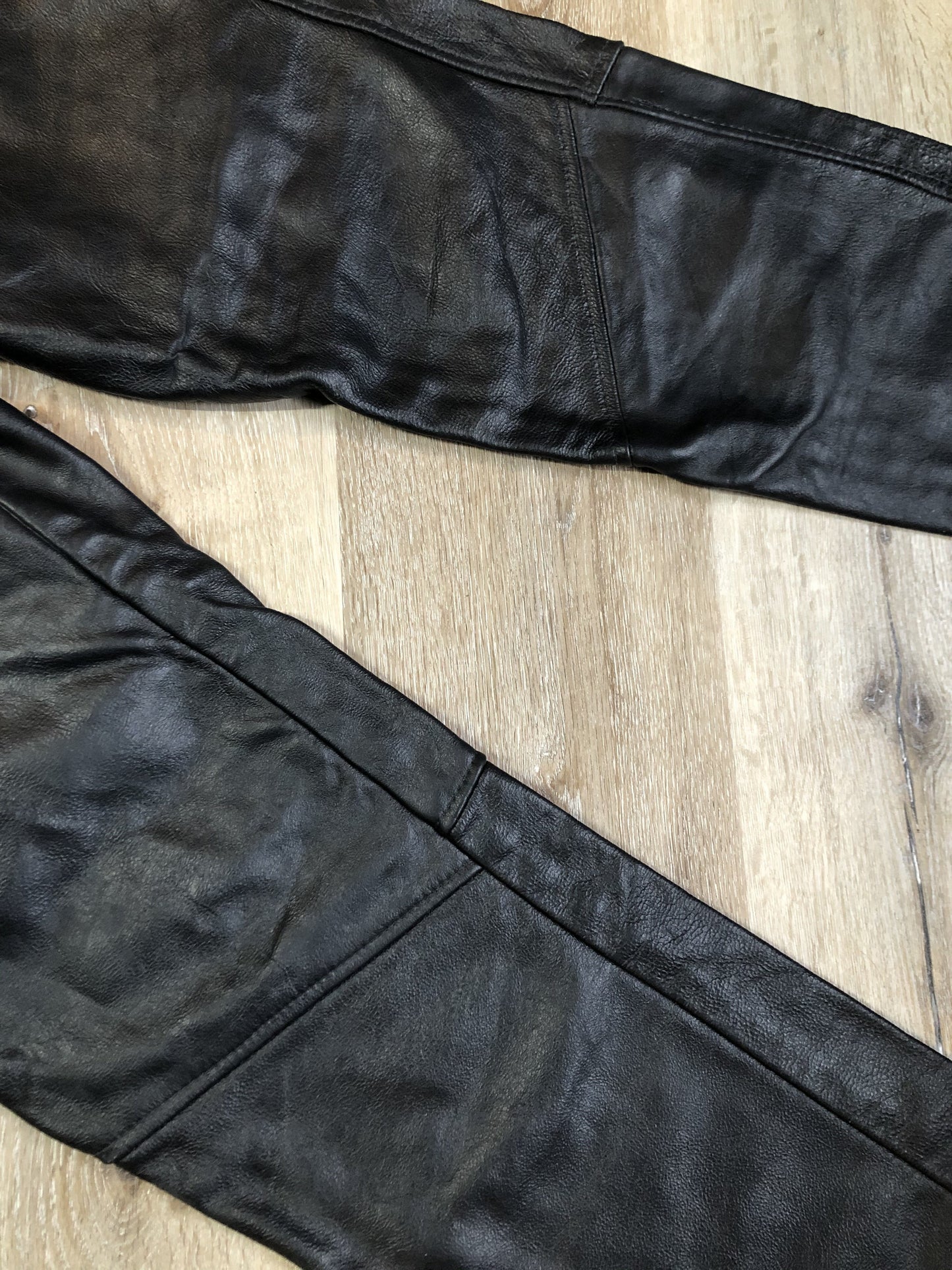 Vintage black full grain leather straight leg pants with zip and snap closure, pockets in the front and back. Size 30x29.