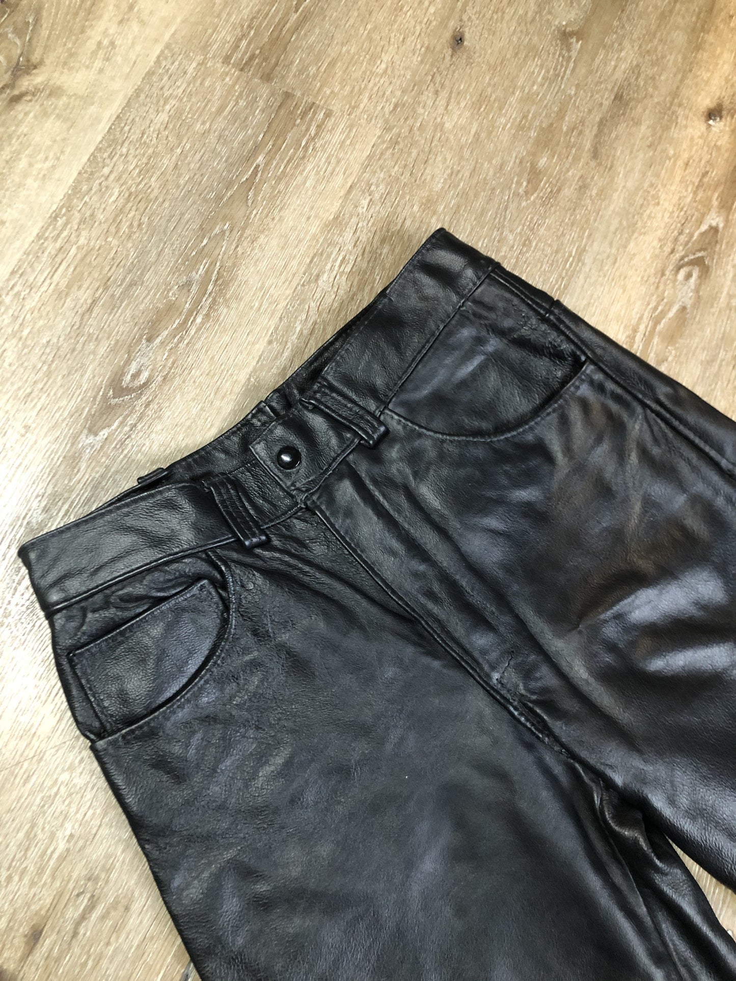 Vintage black full grain leather straight leg pants with zip and snap closure, pockets in the front and back. Size 30x29.