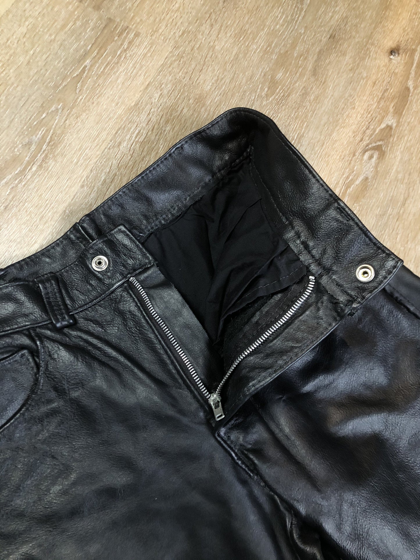 Vintage black full grain leather straight leg pants with zip and snap closure, pockets in the front and back. Size 30x29.