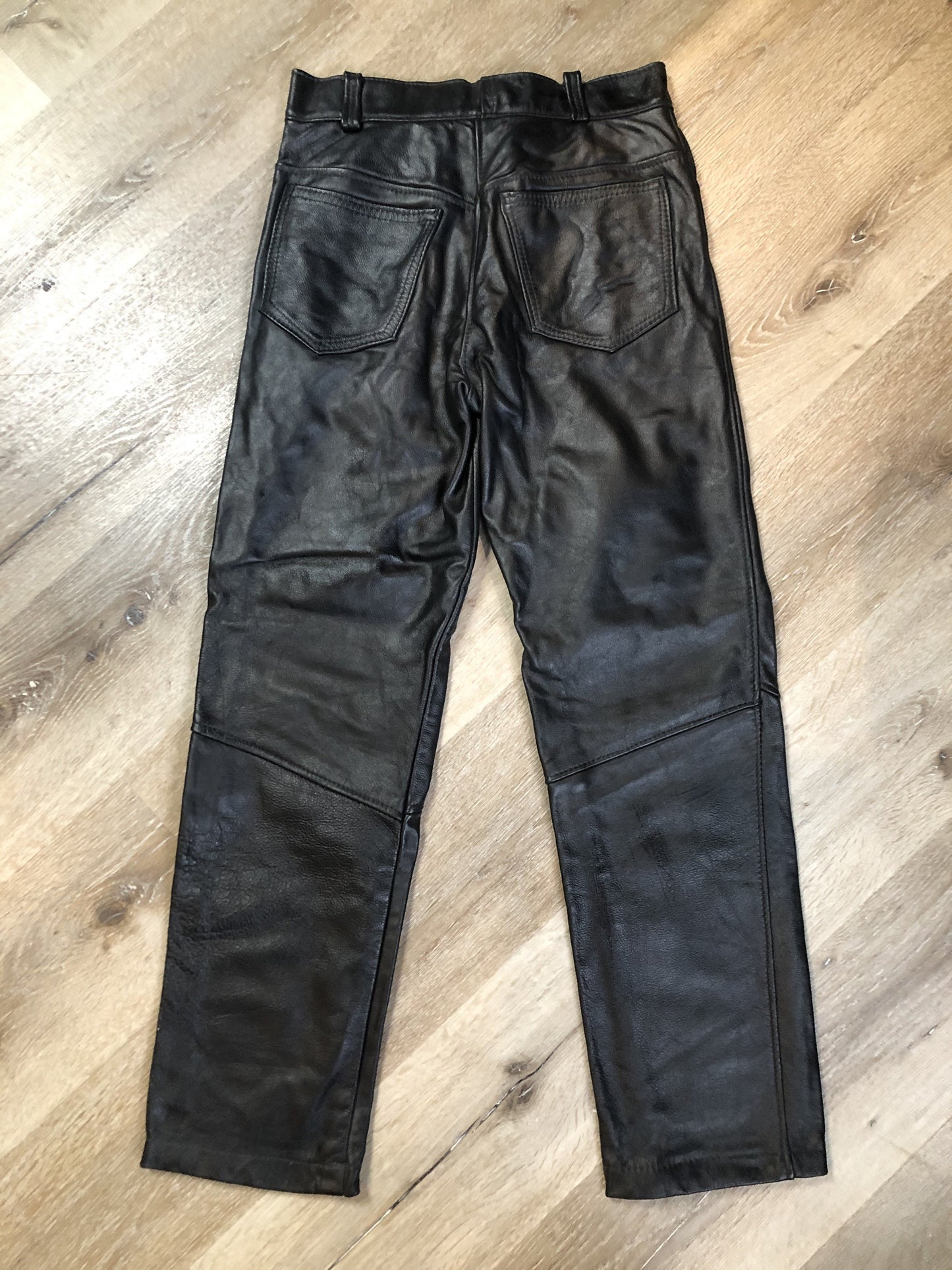 Vintage black full grain leather straight leg pants with zip and snap closure, pockets in the front and back. Size 30x29.