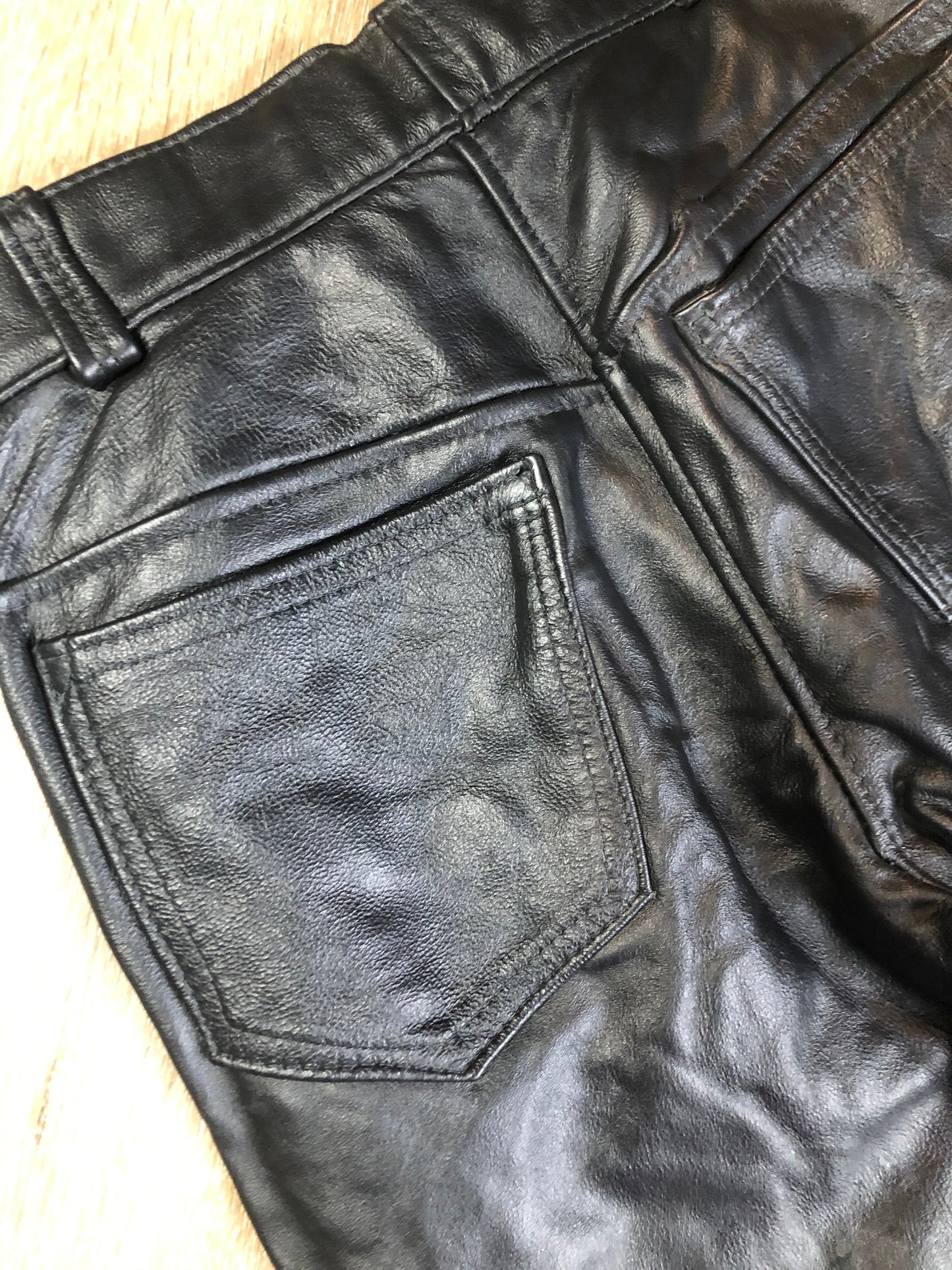 Vintage black full grain leather straight leg pants with zip and snap closure, pockets in the front and back. Size 30x29.