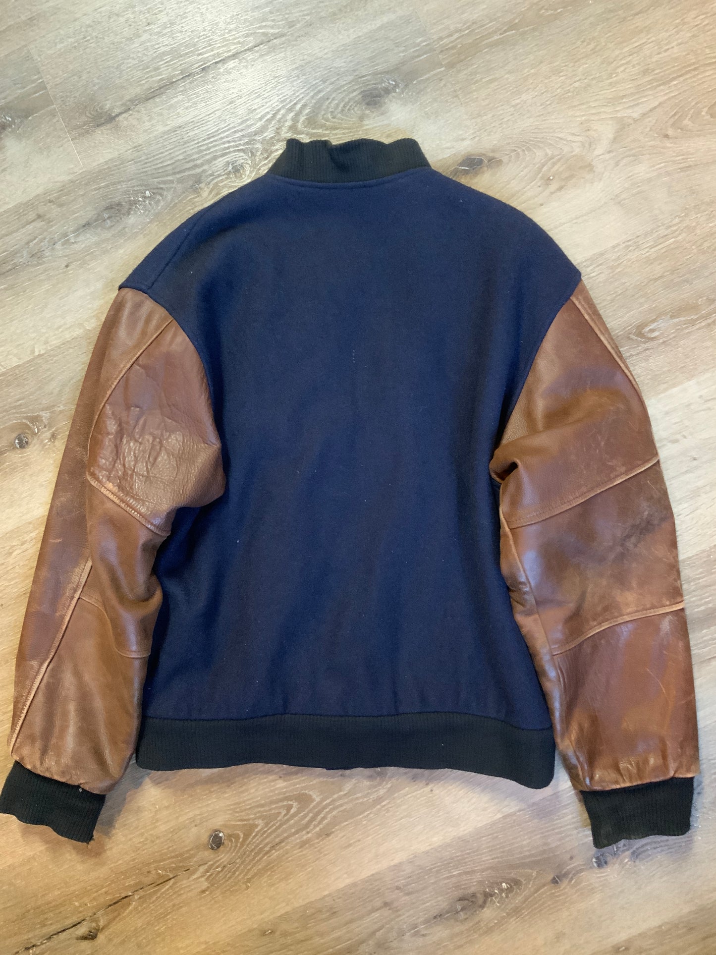Kingspier Vintage - Ford F-Series 50 year anniversary letterman’s jacket in navy with brown leather sleeves, snap closures, slash pockets and an inside pocket.