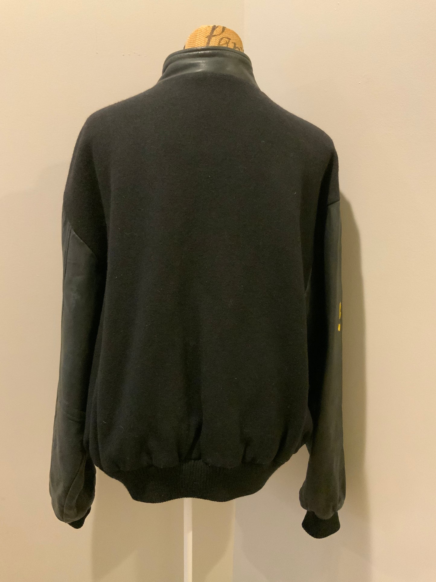 Kingspier Vintage - Dartmouth High School AAA Hockey letterman’s jacket in black with snap closures, slash pockets, quilted lining and embroidered team emblem. Made in Canada. Size XL.