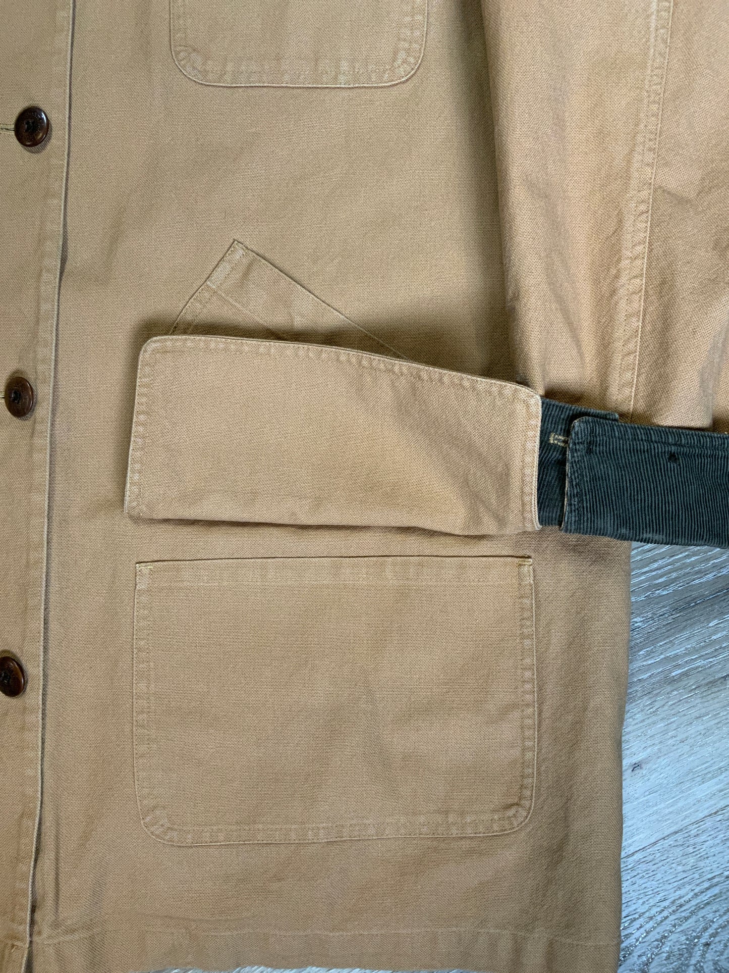 Kingspier Vintage - L.L.Bean beige field jacket with green corduroy collar and cuff, four front patch pockets and one zip pocket, button closures, removable plaid "Prima Loft" synthetic down lining. Size large petite women’s.