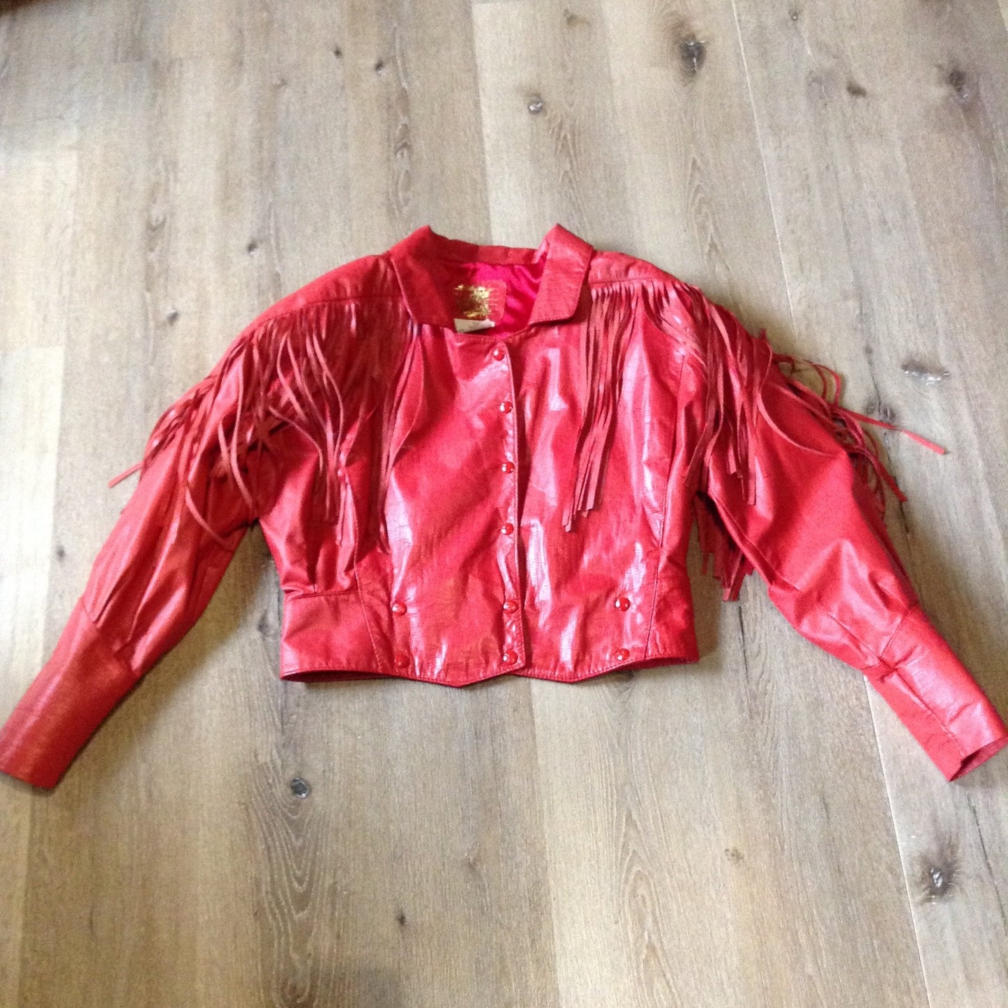 Kingspier Vintage - The Leather Ranch red fringe leather jacket with snap closures and red satin lining . Made in Canada, size XL.
