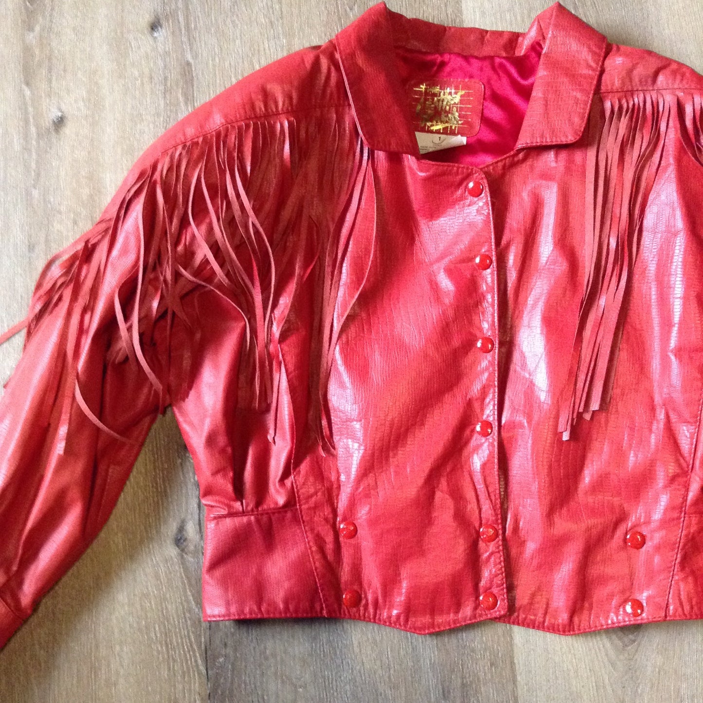 Kingspier Vintage - The Leather Ranch red fringe leather jacket with snap closures and red satin lining . Made in Canada, size XL.