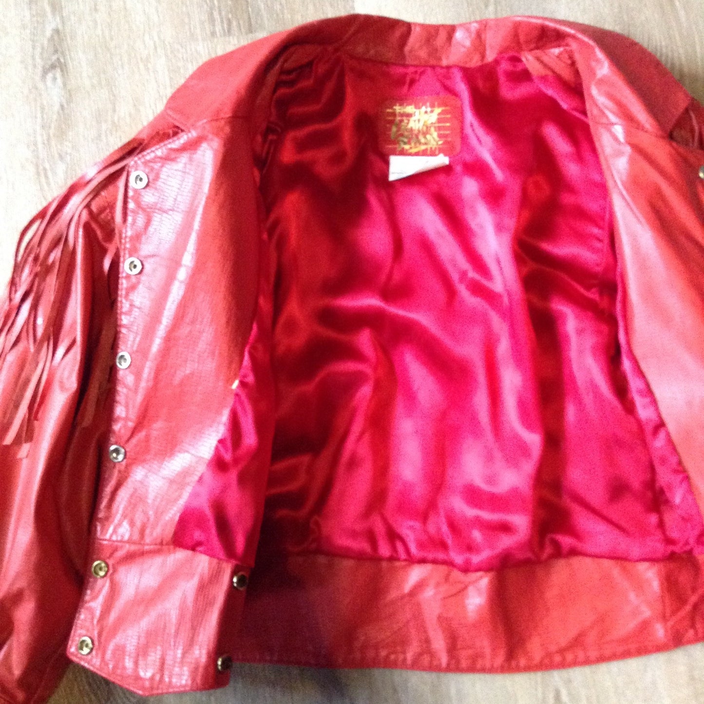 Kingspier Vintage - The Leather Ranch red fringe leather jacket with snap closures and red satin lining . Made in Canada, size XL.