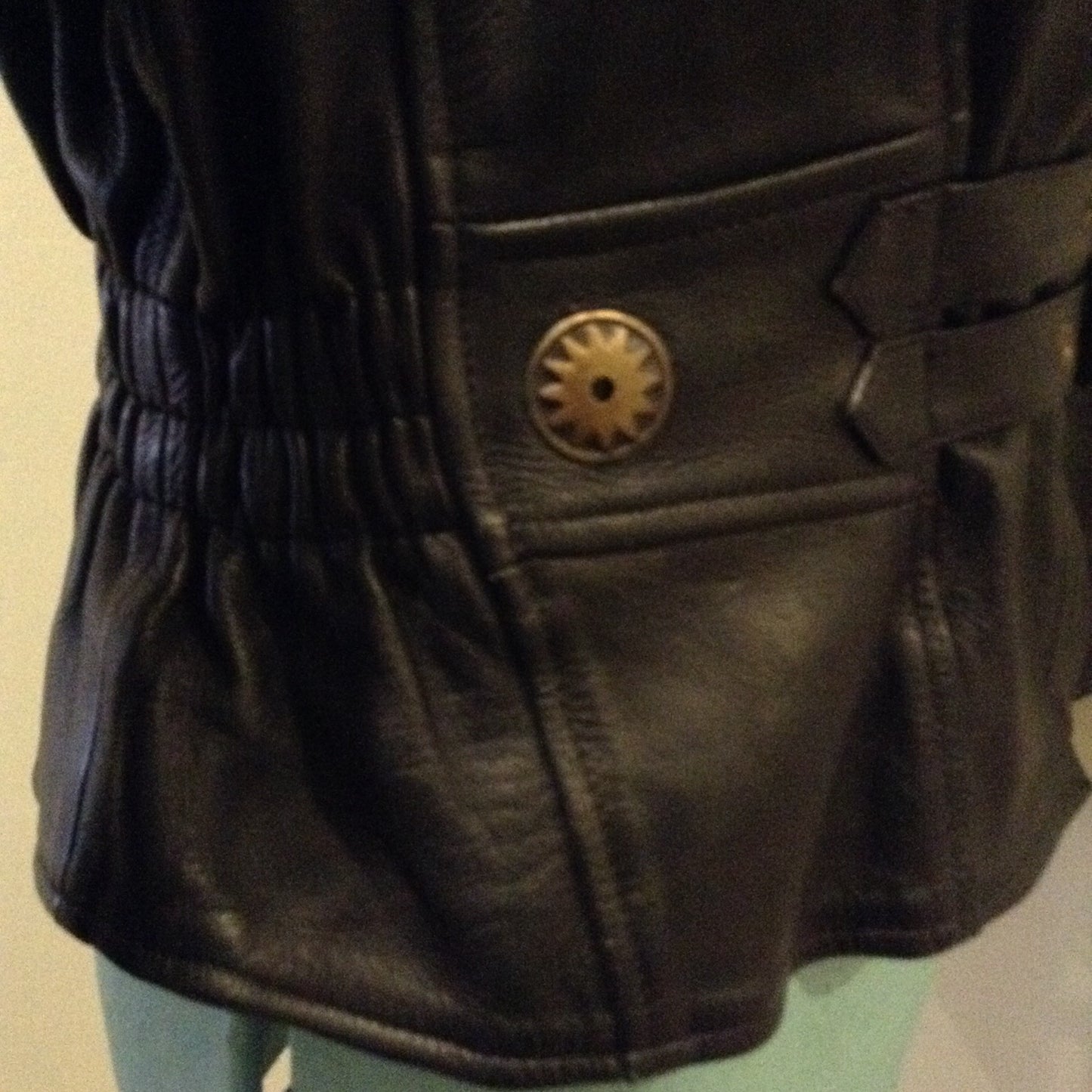 Kingspier Vintage -Vintage black leather moto jacket with brass hardware and zipper closure, belt details and a zipper reveals a vent in the back . Size large.