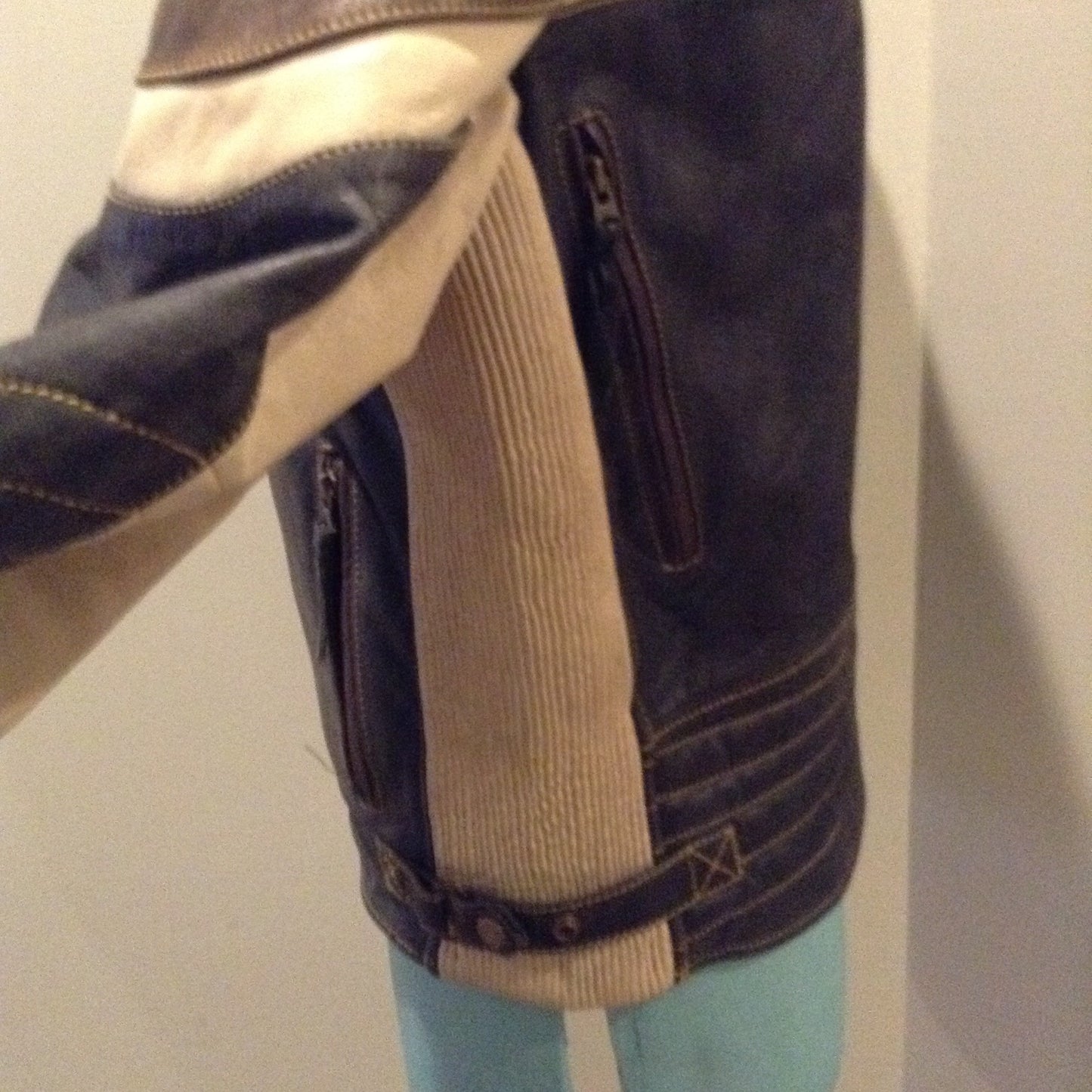 Kingspier Vintage -Vintage CCM Canada black, white and brown leather moto jacket with zipper closure, pockets and a snap collar. Size XL.