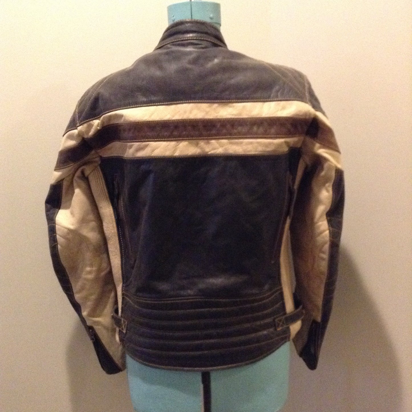 Kingspier Vintage -Vintage CCM Canada black, white and brown leather moto jacket with zipper closure, pockets and a snap collar. Size XL.