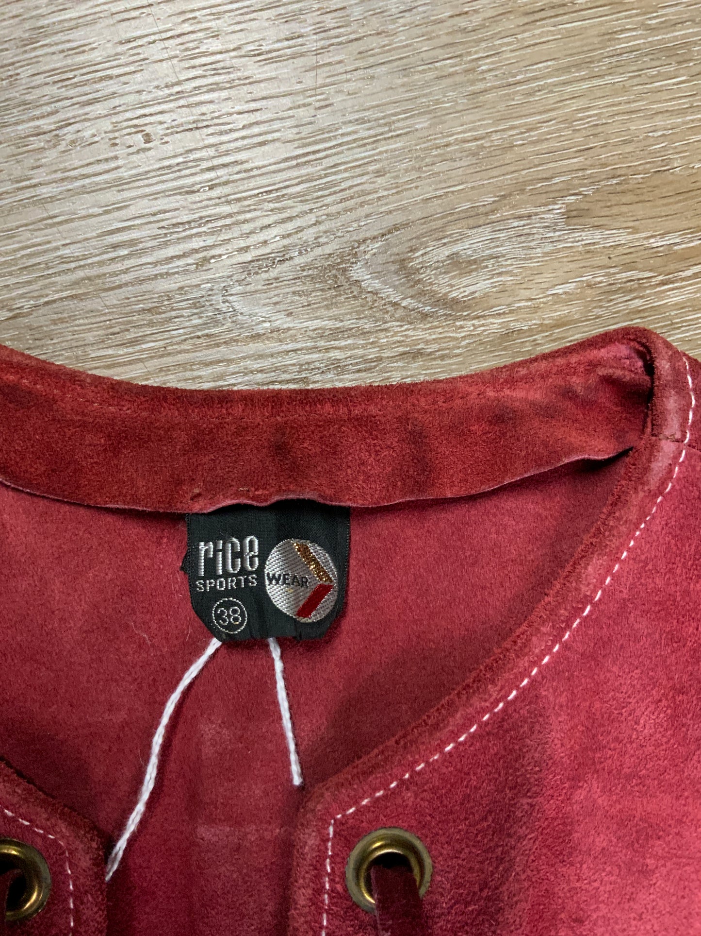 Kingspier Vintage - Rice Sports Wear red suede vest with lace up detail in the front, side zipper and two flap pockets. Made in Canada. Size 38.