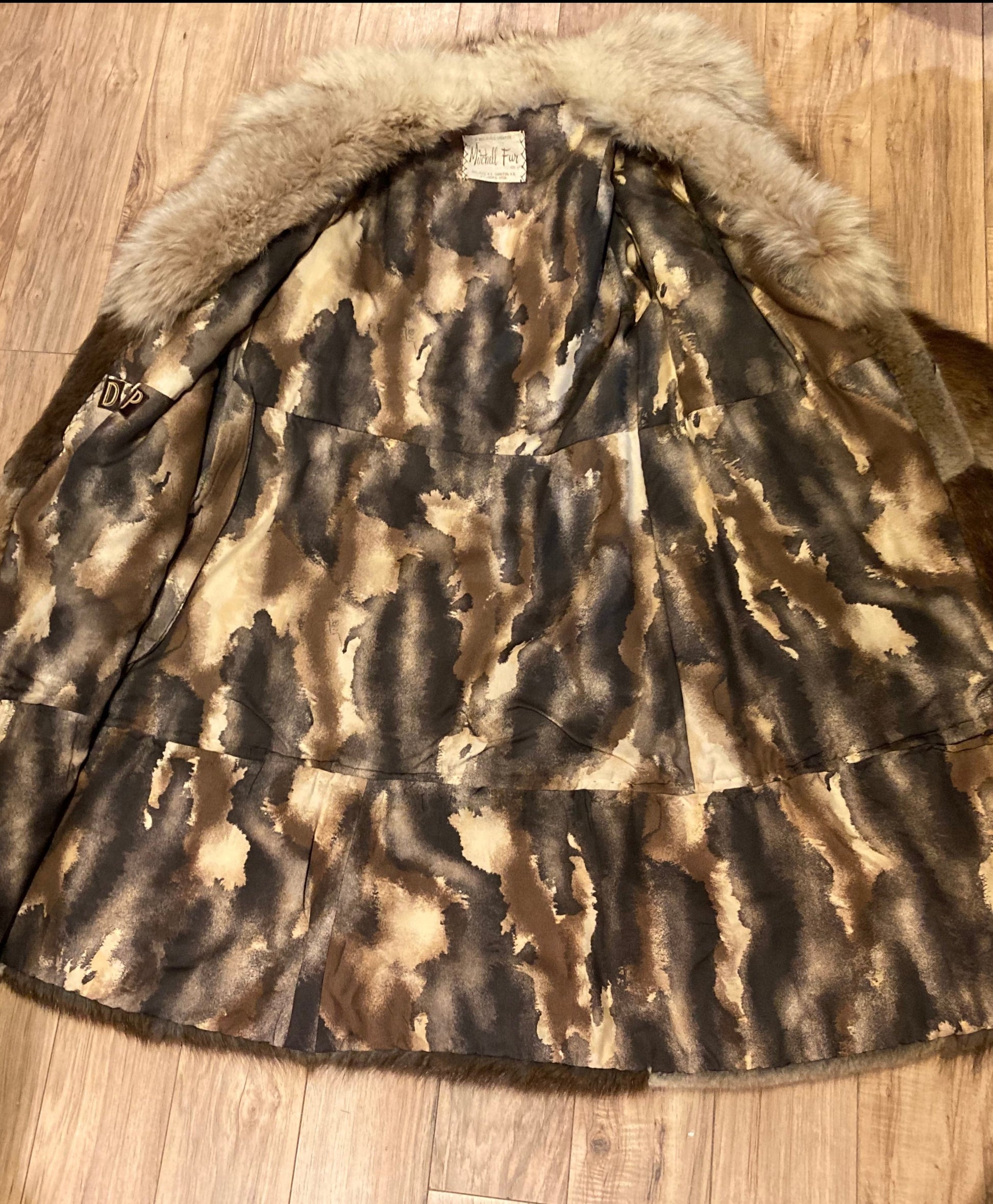 Kingspier Vintage - Vintage 70’s Mitchell Fur Co. Fur Coat features an exaggerated fur collar, double breasted button closures, D,A,P monogram and a bottom portion that zips off to give the option of a shorter jacket.
Made in Canada.