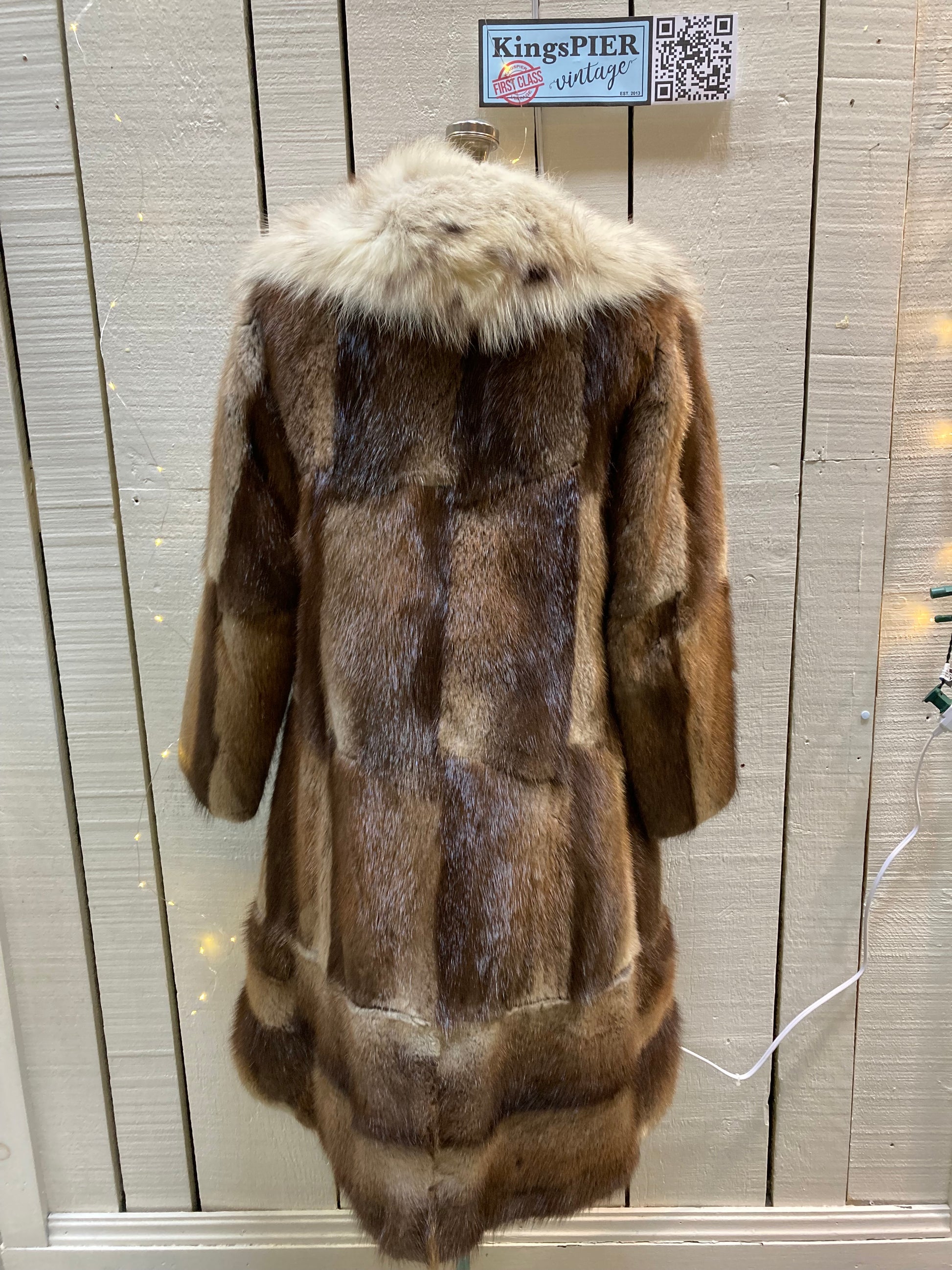 Kingspier Vintage - Vintage 70’s Mitchell Fur Co. Fur Coat features an exaggerated fur collar, double breasted button closures, D,A,P monogram and a bottom portion that zips off to give the option of a shorter jacket.
Made in Canada.