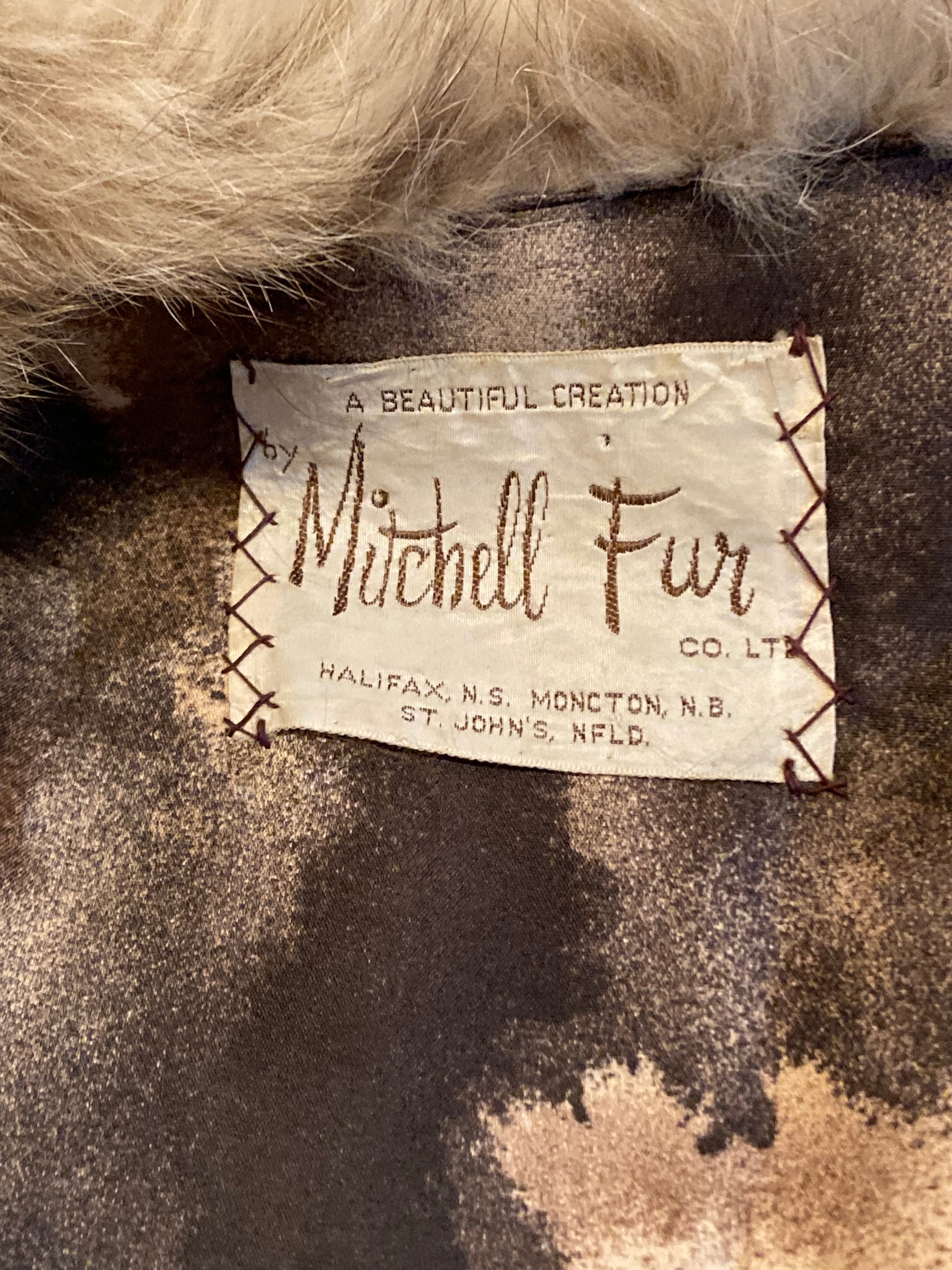 Kingspier Vintage - Vintage 70’s Mitchell Fur Co. Fur Coat features an exaggerated fur collar, double breasted button closures, D,A,P monogram and a bottom portion that zips off to give the option of a shorter jacket.
Made in Canada.