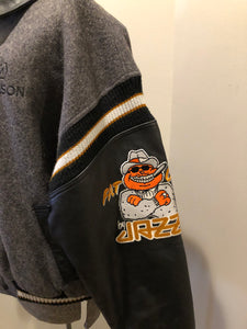Kingspier Vintage - Fat Cat by Jazz grey and black wool varsity jacket with two large custom Jazz Golf embroidered patches on the arm and the back and Molson is embroidered on the chest in black, leather sleeves and collar, pockets, snap closures, knit details and a quilted lining. Made in Canada by Mondetta . Size XL.