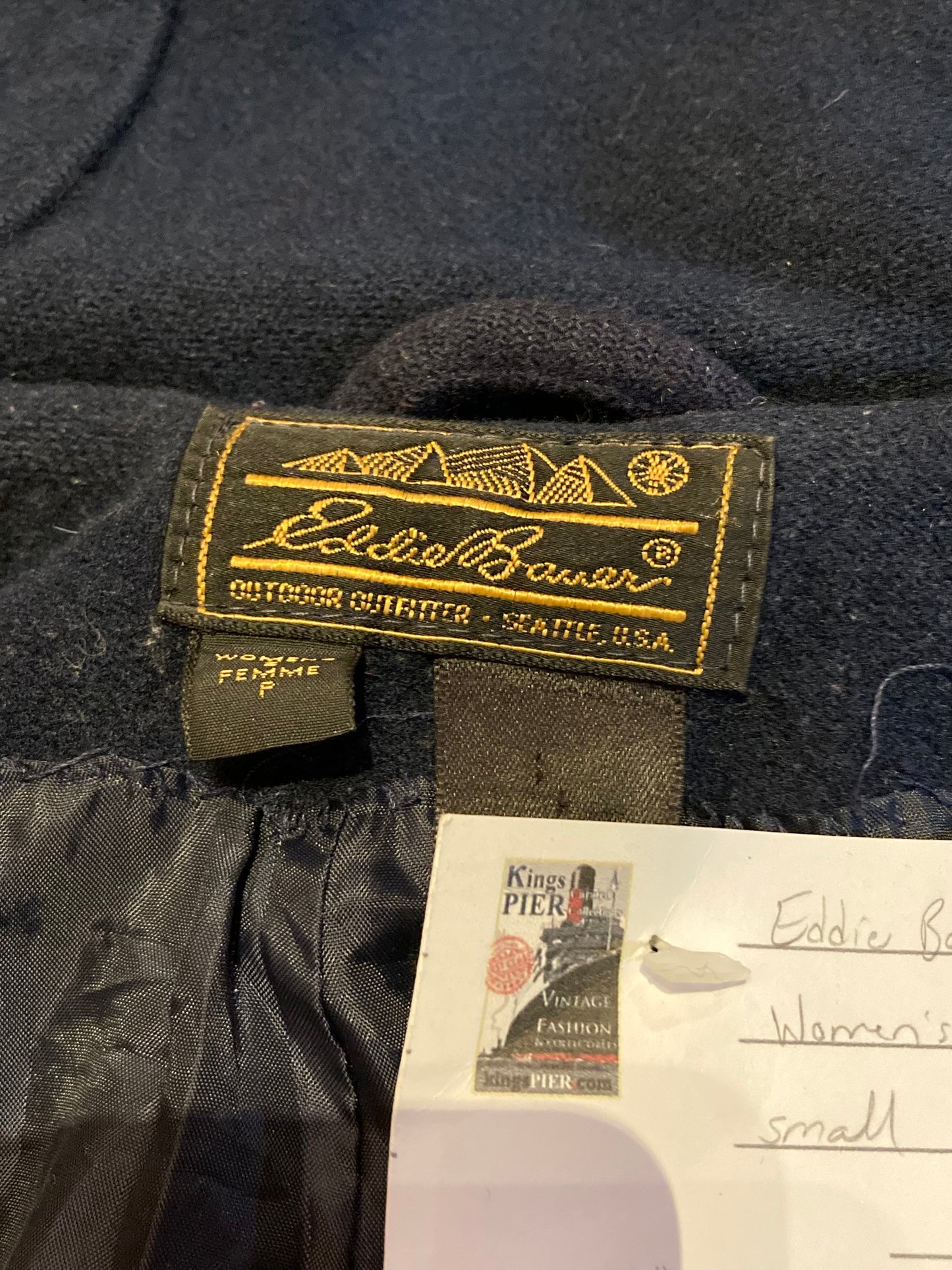 Kingspier Vintage - Eddie Bauer blue duffle coat with hood, antler toggle closures and front patch pockets. Fibres unknown.
Size Small