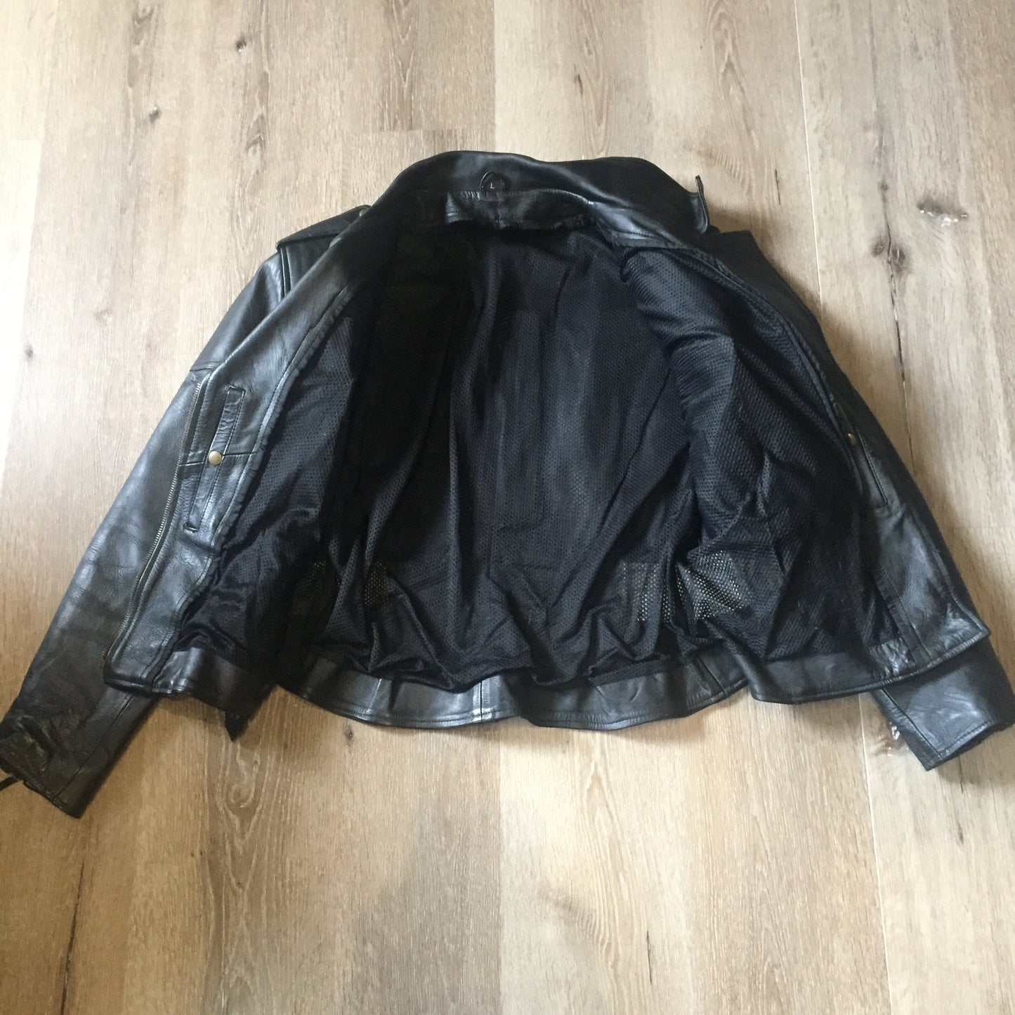 Kingspier Vintage -Vintage black leather moto jacket with brass hardware and zipper closure, belt details and a zipper reveals a vent in the back . Size large.