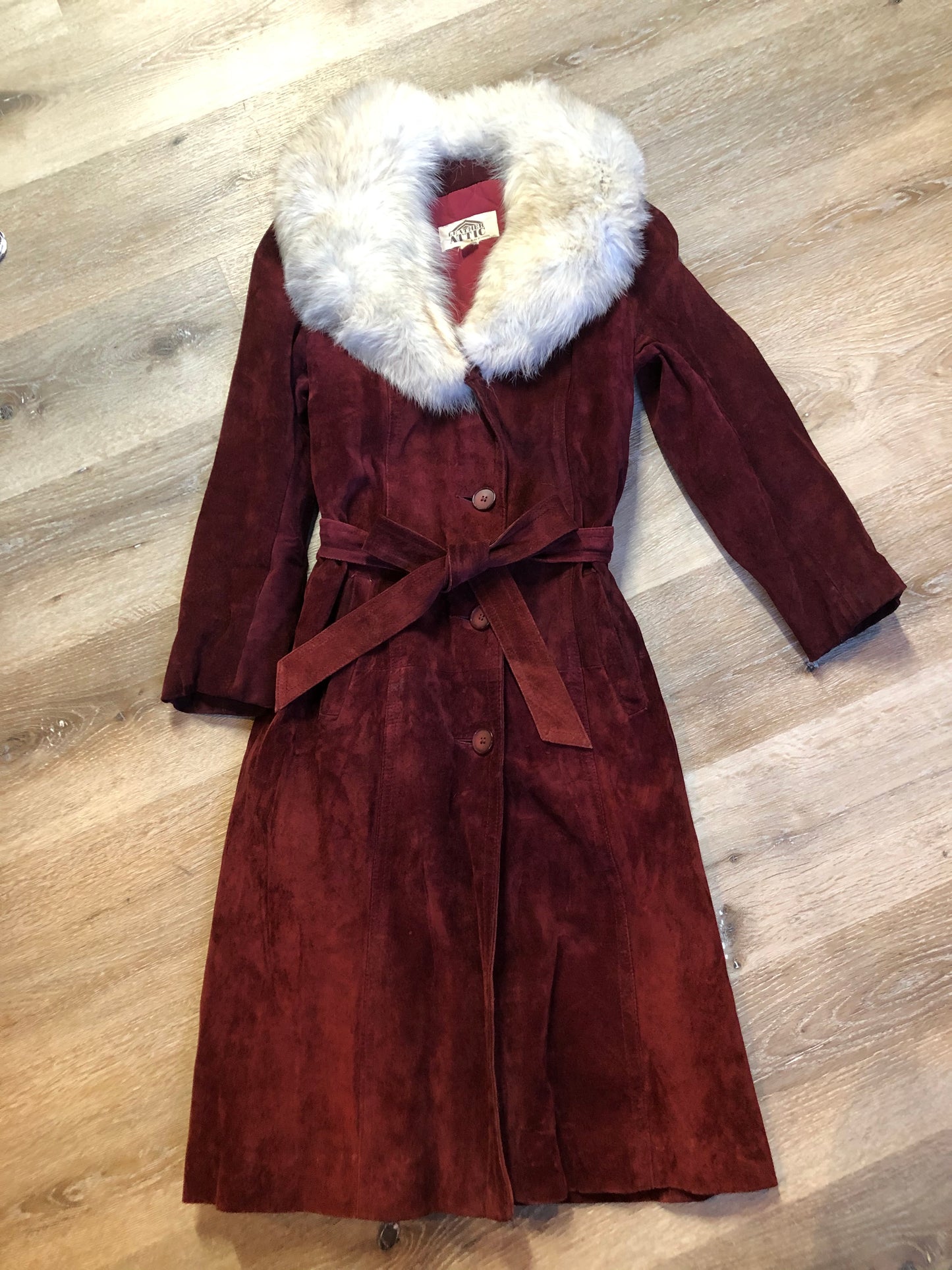 Kingspier Vintage - Leather Attic 1970’s oxblood suede coat with fur collar. Beautifully fitted, the coat features pockets, buttons, a belt and a quilted lining. Made in Canada. Size small.