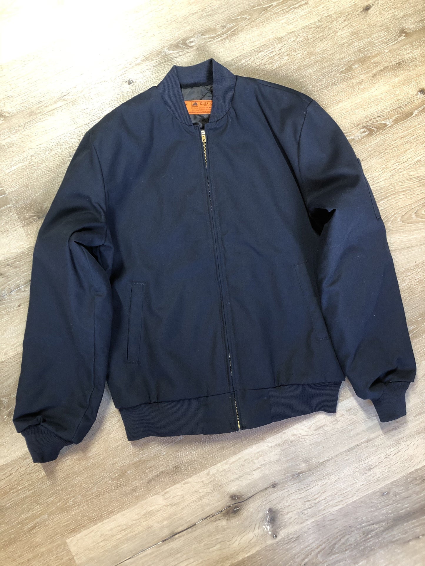 Kingspier Vintage - Red Kap bomber jacket in navy with knit collar and cuffs, zipper, slash pockets, and quilted lining. Made in the USA.