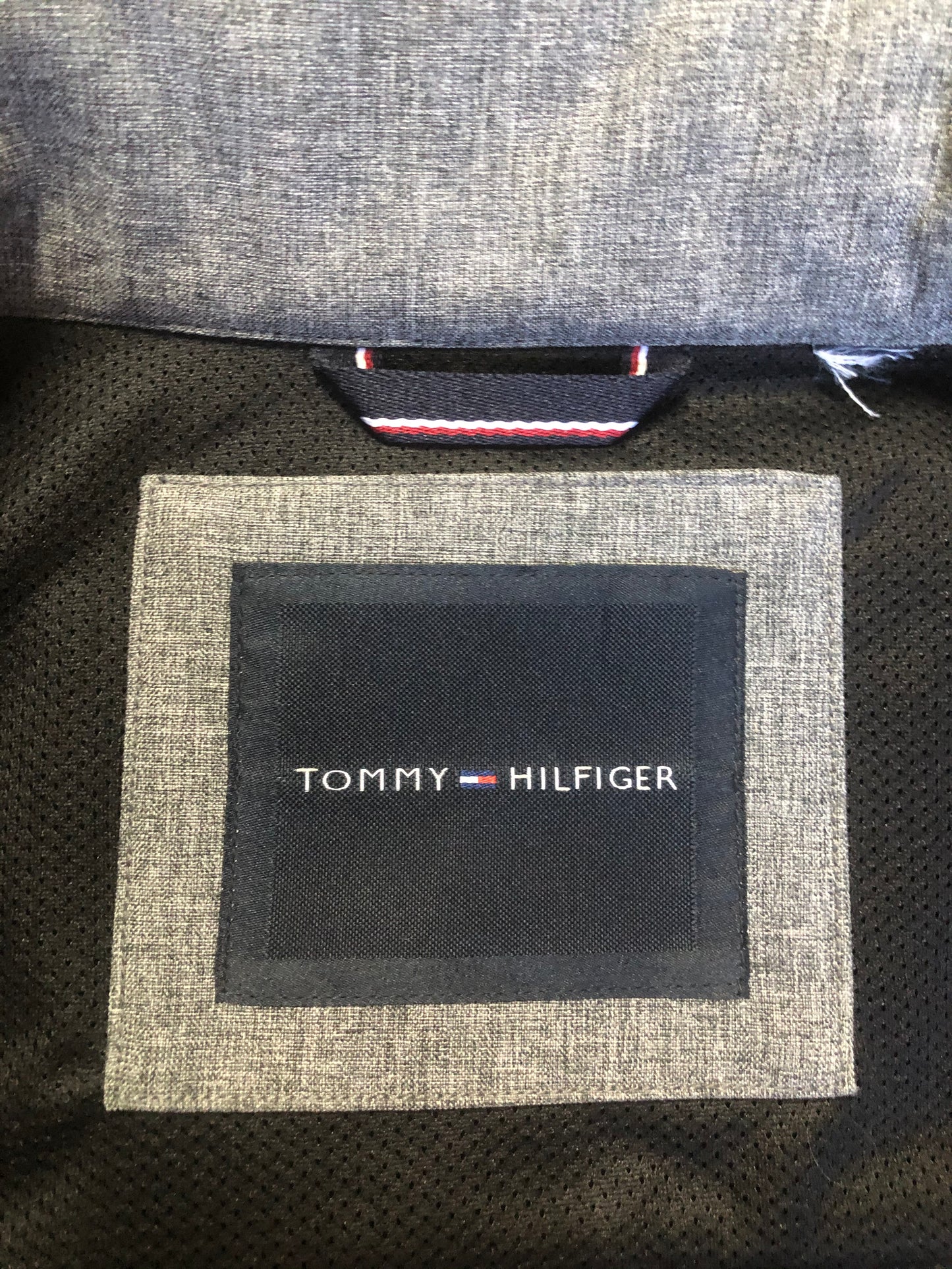 Kingspier Vintage - Tommy Hilfiger grey jacket with zipper, front slash pockets and inside pocket.