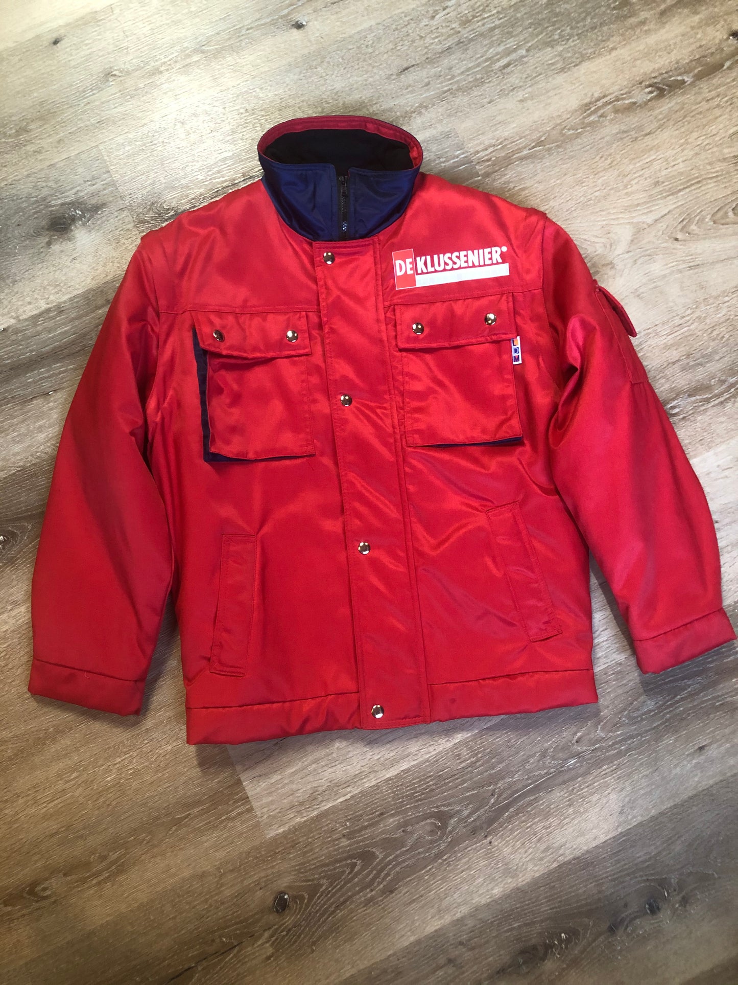 Kingspier Vintage - Deklussenier red jacket with funnel neck, zipper and snap closures, snap closures at wrist and waist, two top flap pockets and two slash pockets, zip off sleeves and zip out quilted lining. Size S.