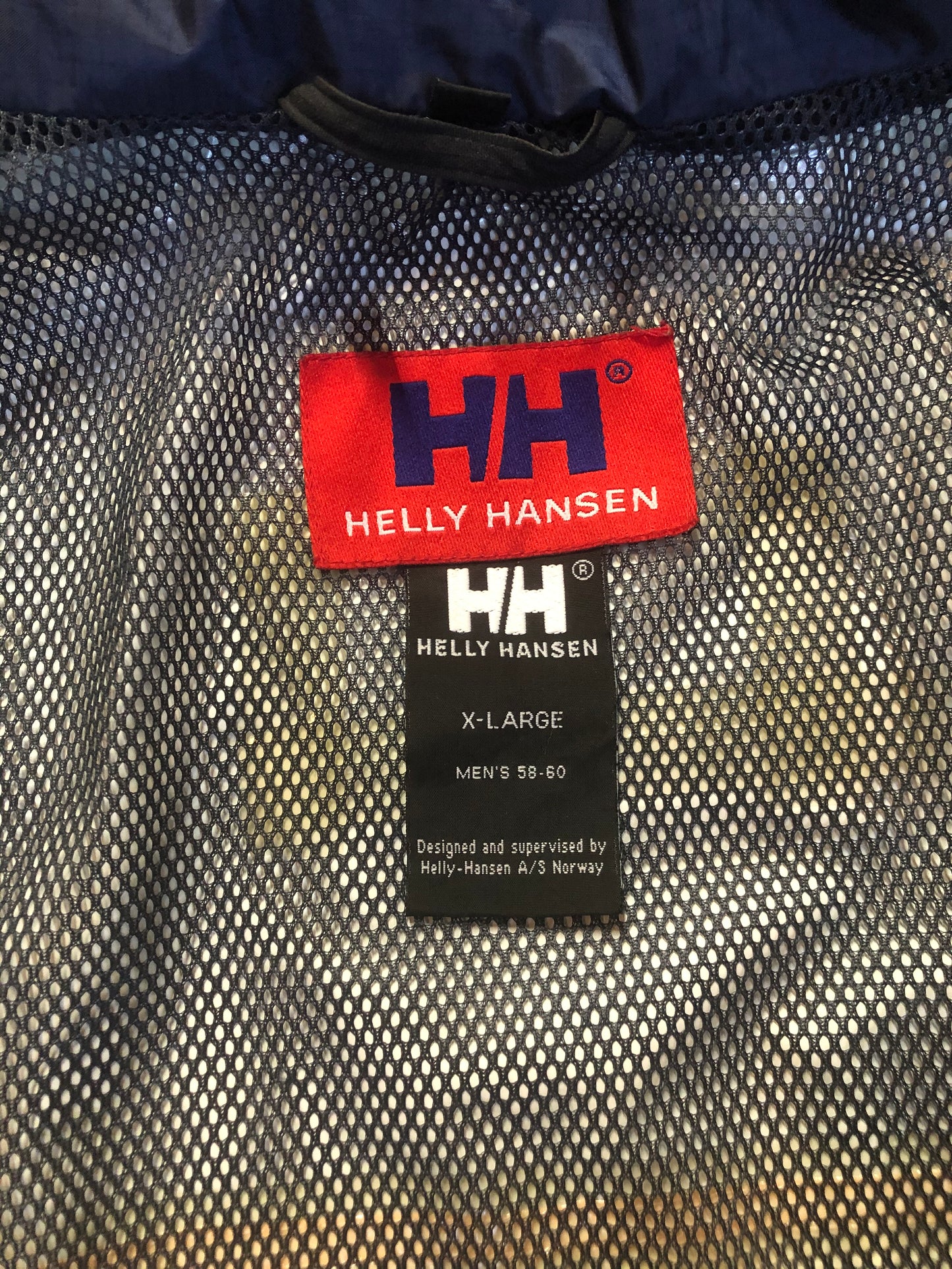 Kingspier Vintage - Heely Hansen ”Extreme” white,yellow and navy windbreaker with funnel neck and roll up hood, zipper and Velcro closures, reflective square on front and Helly Hansen patch on arm. Size XL.
