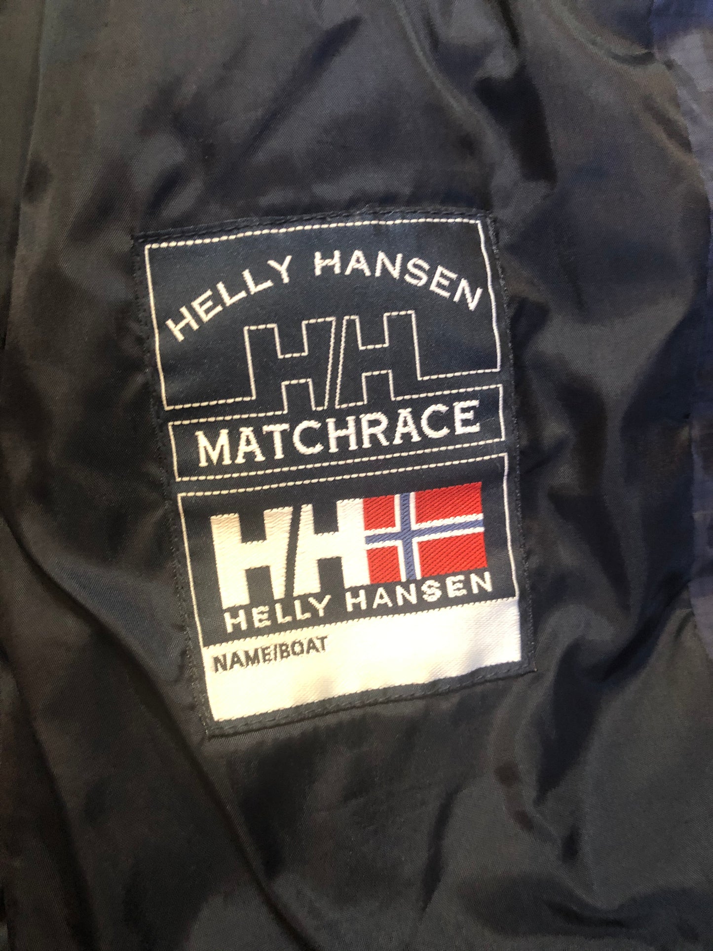 Kingspier Vintage - Heely Hansen ”Extreme” white,yellow and navy windbreaker with funnel neck and roll up hood, zipper and Velcro closures, reflective square on front and Helly Hansen patch on arm. Size XL.