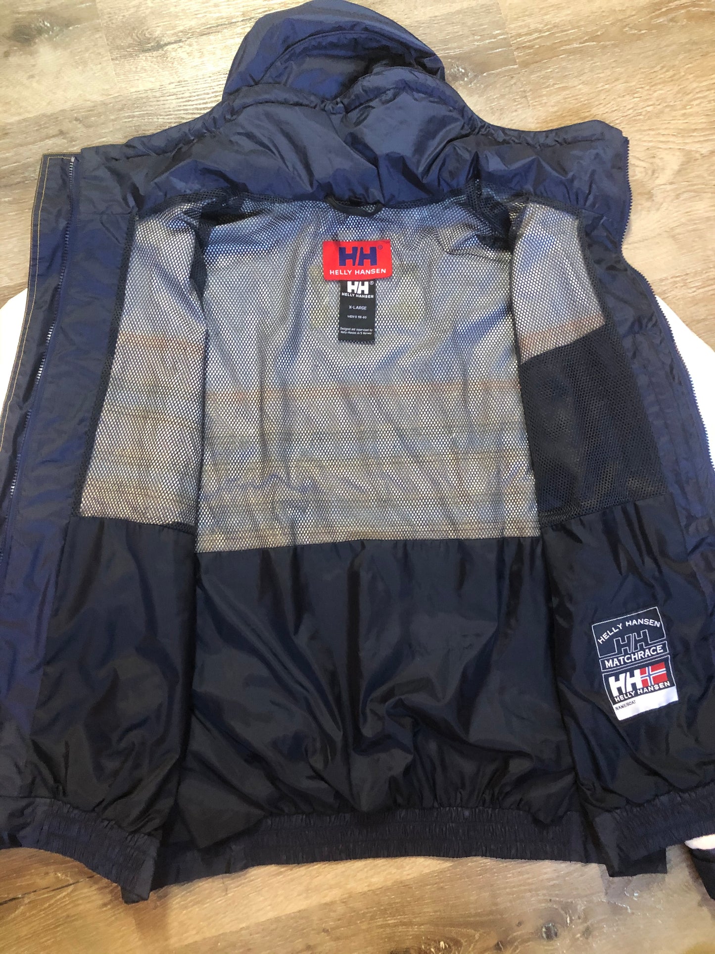 Kingspier Vintage - Heely Hansen ”Extreme” white,yellow and navy windbreaker with funnel neck and roll up hood, zipper and Velcro closures, reflective square on front and Helly Hansen patch on arm. Size XL.
