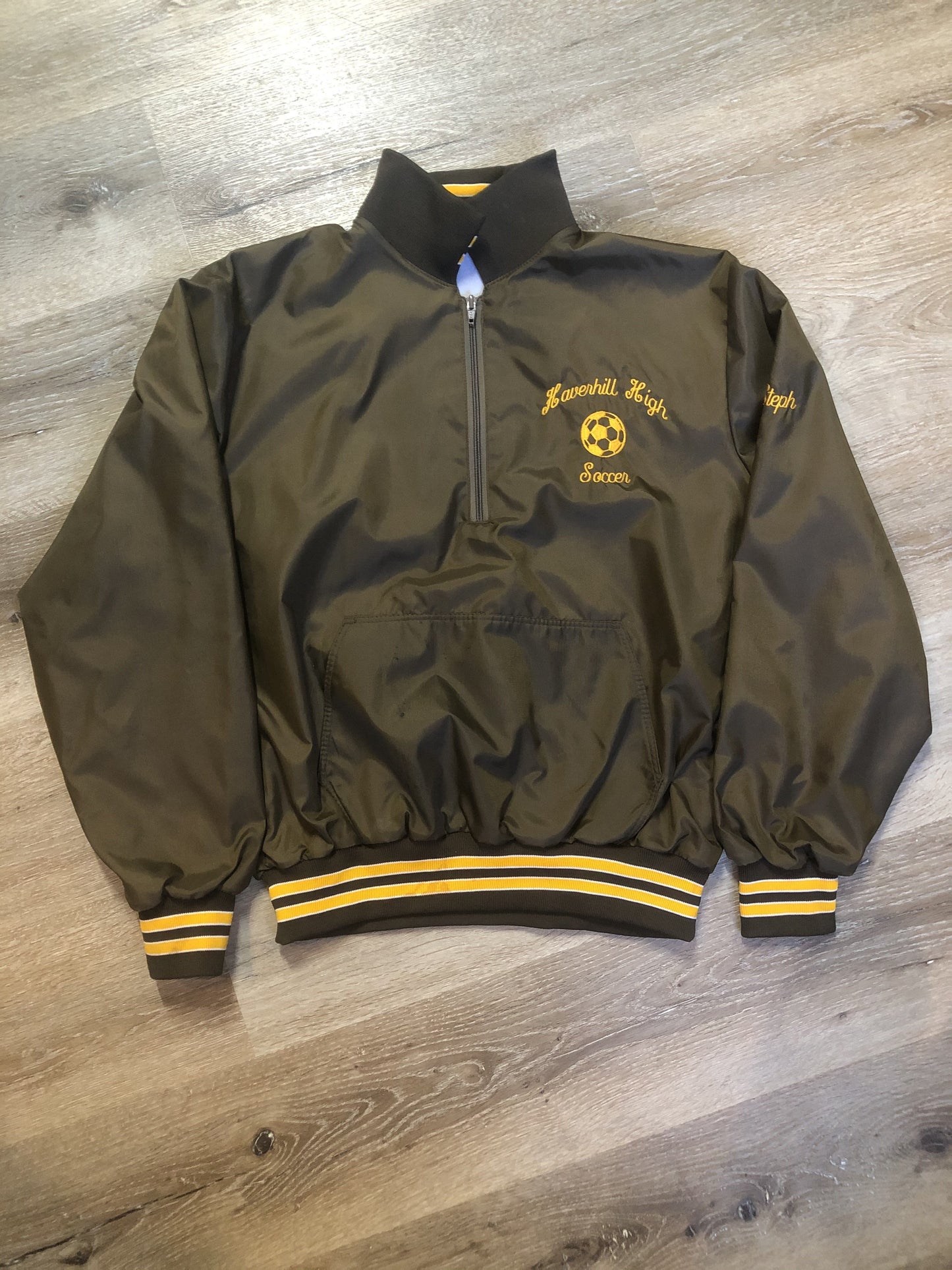 Kingspier Vintage - Havenhill High Soccer varsity jacket in brown with yellow stripe, zipper, front pouch pocket, “Havenhill High” written across the back and “Steph” monogram on the arm. Made in the USA. Size large.