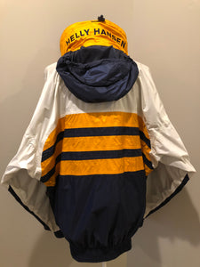 Kingspier Vintage - Heely Hansen ”Extreme” white,yellow and navy windbreaker with funnel neck and roll up hood, zipper and Velcro closures, reflective square on front and Helly Hansen patch on arm. Size XL.