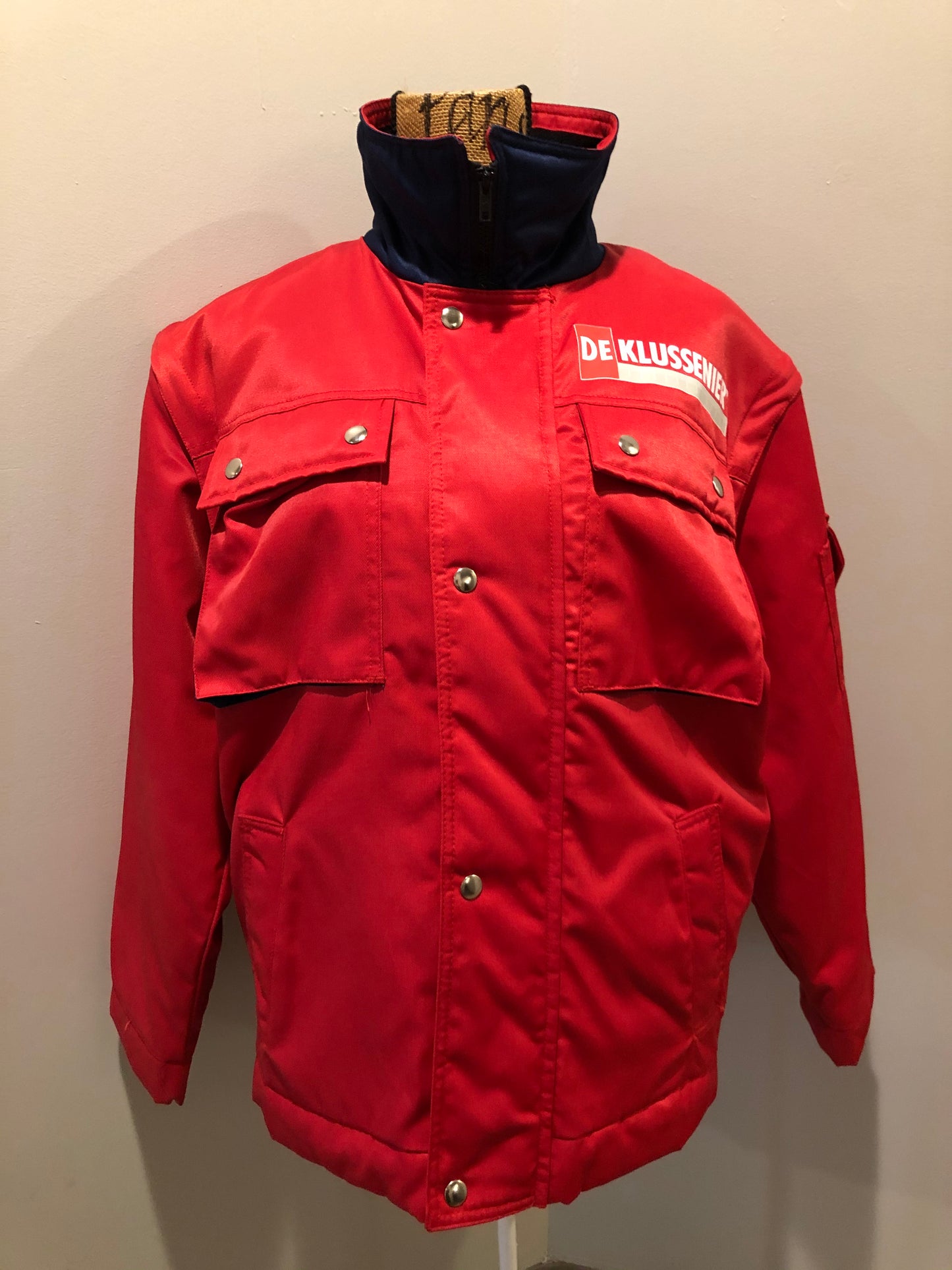 Kingspier Vintage - Deklussenier red jacket with funnel neck, zipper and snap closures, snap closures at wrist and waist, two top flap pockets and two slash pockets, zip off sleeves and zip out quilted lining. Size S.