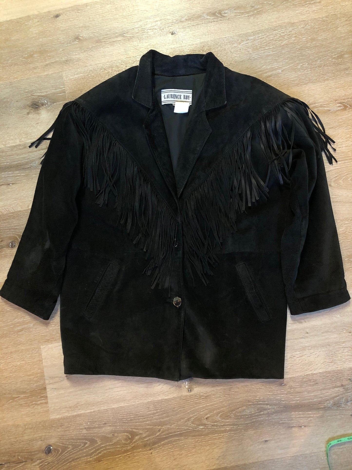 Kingspier Vintage - Laurence Roy black lamb leather suede jacket circa 1980’s with fringe detailing, button closures and slash pockets. Made in Canada. Size large.
