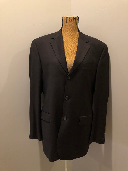 Kingspier Vintage - Bill Blass dark brown 100% pure wool two piece suit. The jacket is a single breasted three button notch lapel with two flap pockets and a beige lining with two inside pockets, Pants are pleated with welt pockets.