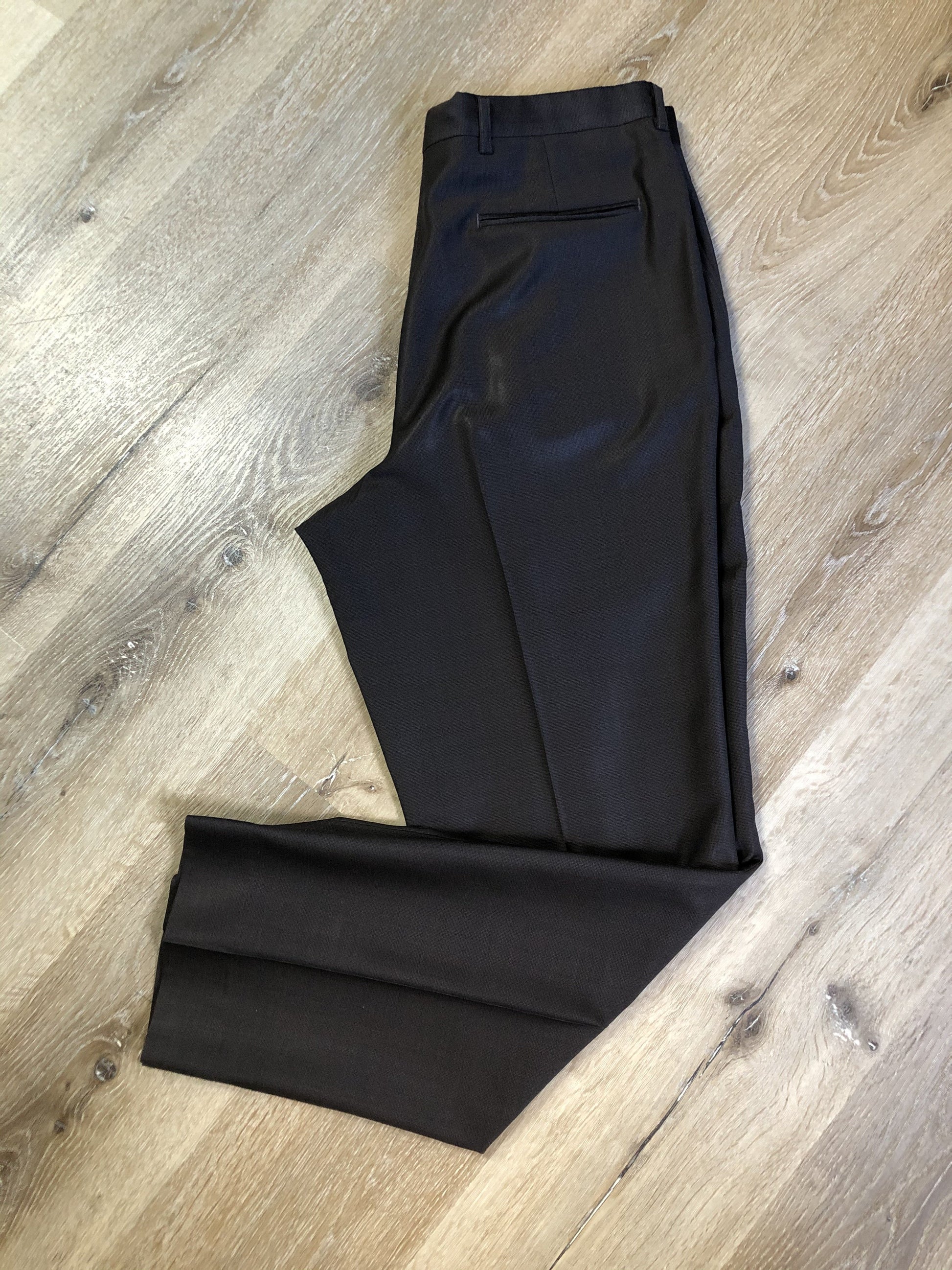 Kingspier Vintage - Bill Blass dark brown 100% pure wool two piece suit. The jacket is a single breasted three button notch lapel with two flap pockets and a beige lining with two inside pockets, Pants are pleated with welt pockets.