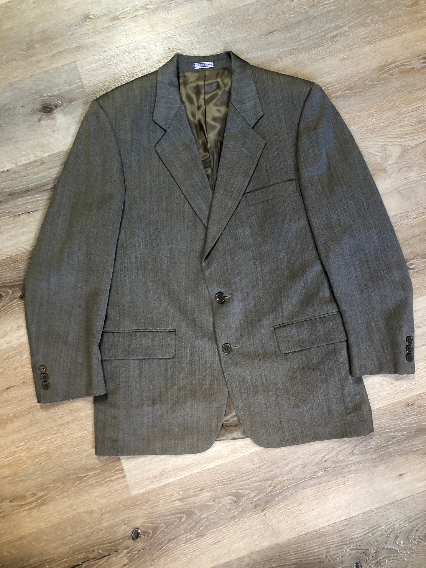 Kingspier Vintage - WM.H. Leishman ( at Tip Top Tailors) two piece medium grey 100% pure virgin wool suit.The jacket is a single breasted, two button notch lapel with two flap pockets and two inside pockets. Pants are pleated with welt pockets. Made in Canada.
