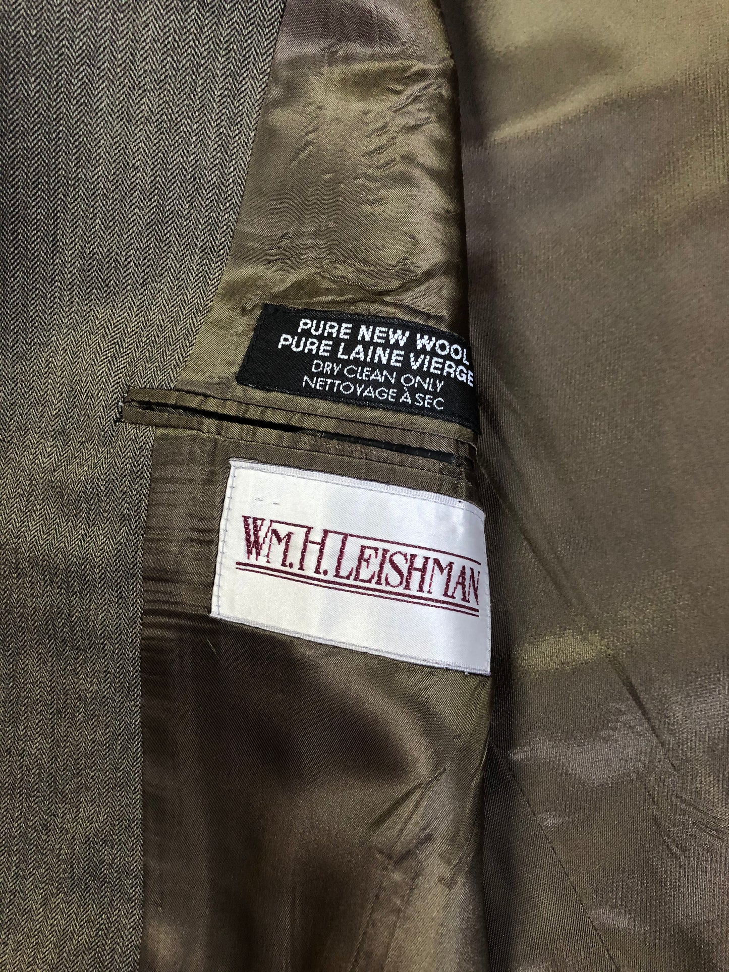 Kingspier Vintage - WM.H. Leishman ( at Tip Top Tailors) two piece medium grey 100% pure virgin wool suit.The jacket is a single breasted, two button notch lapel with two flap pockets and two inside pockets. Pants are pleated with welt pockets. Made in Canada.