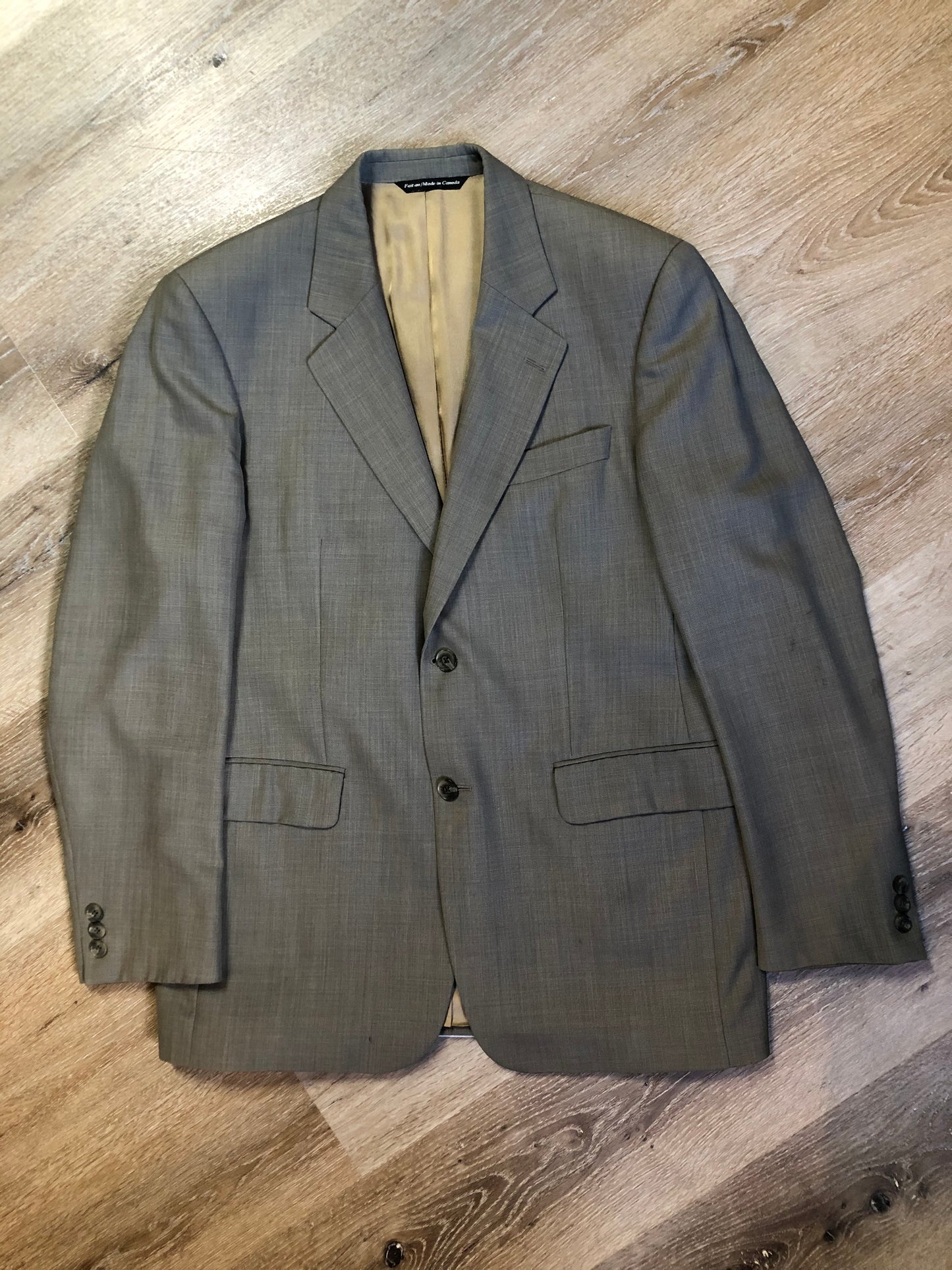 Kingspier Vintage - WM.H. Leishman (sold at Tip Top Tailors) two piece medium grey 100% pure virgin wool suit.The jacket is a single breasted, two button notch lapel with two flap pockets and two inside pockets. Pants are pleated with welt pockets. Made in Canada.
