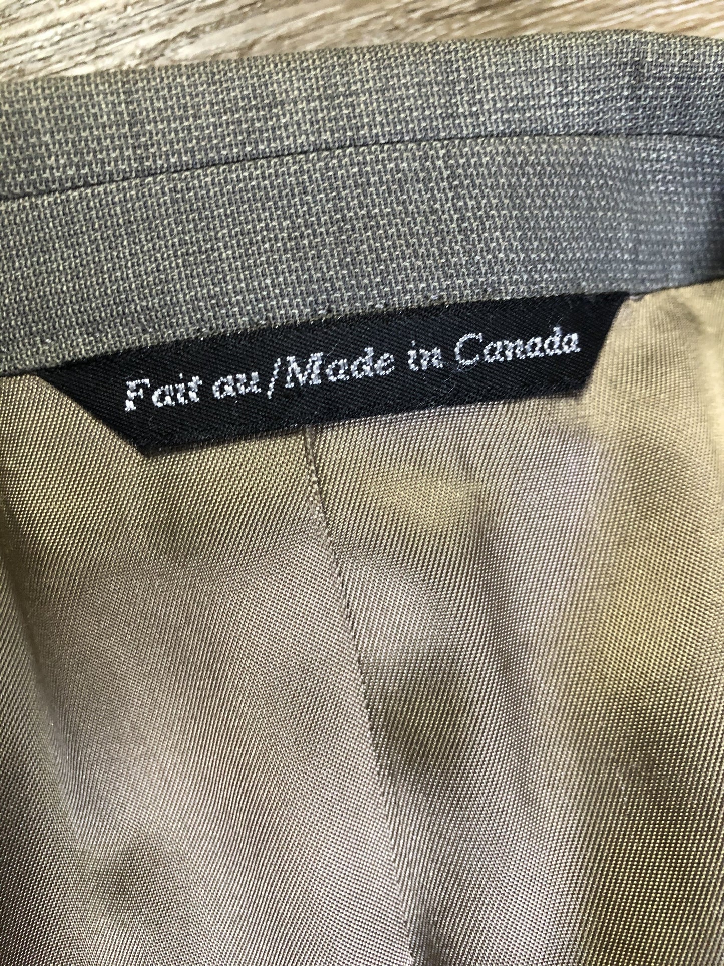 Kingspier Vintage - WM.H. Leishman (sold at Tip Top Tailors) two piece medium grey 100% pure virgin wool suit.The jacket is a single breasted, two button notch lapel with two flap pockets and two inside pockets. Pants are pleated with welt pockets. Made in Canada.