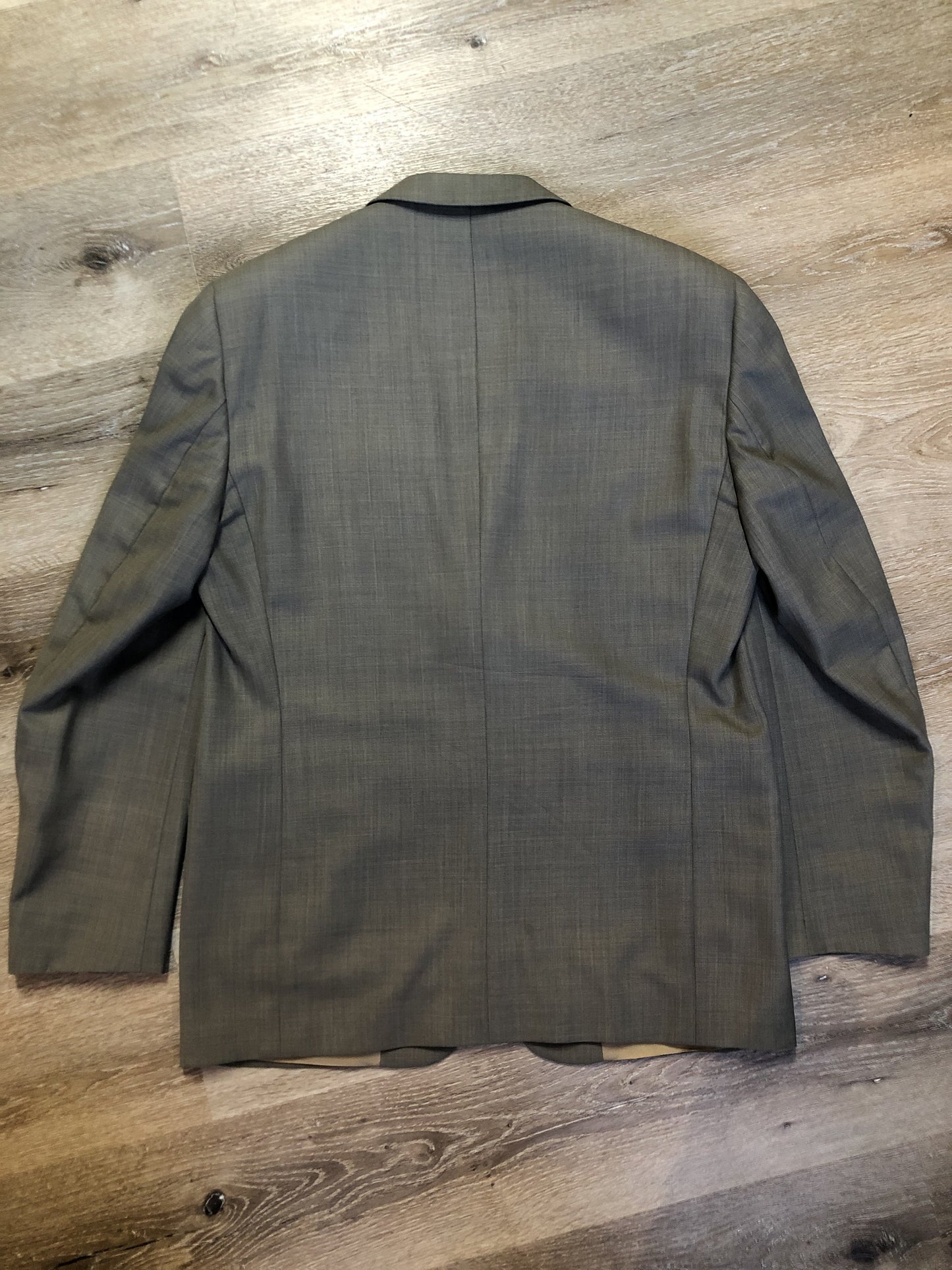 Kingspier Vintage - WM.H. Leishman (sold at Tip Top Tailors) two piece medium grey 100% pure virgin wool suit.The jacket is a single breasted, two button notch lapel with two flap pockets and two inside pockets. Pants are pleated with welt pockets. Made in Canada.