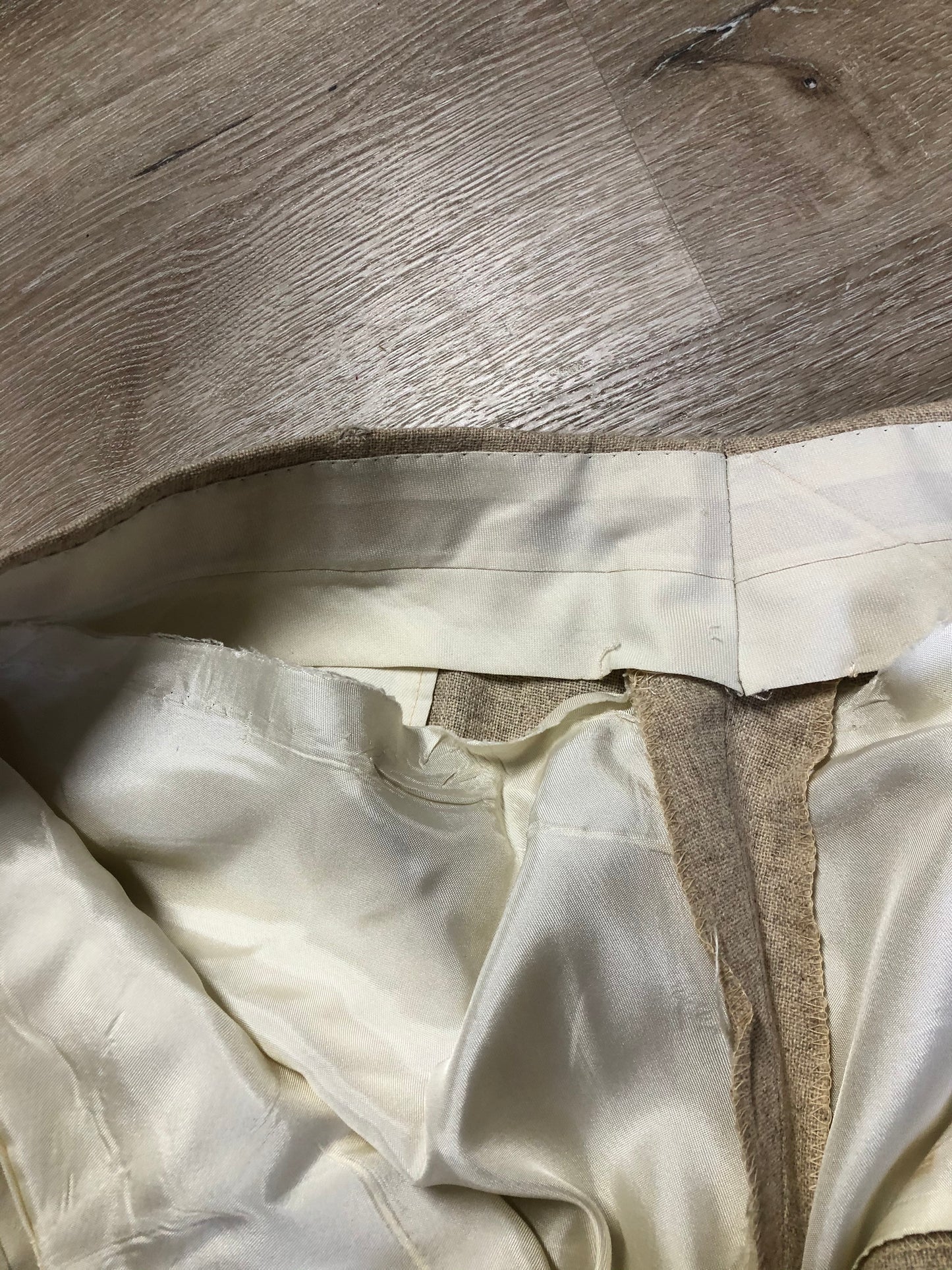 Kingspier Vintage - Chaps by Ralph Lauren light beige two piece suit at Martini Carl Boston. Jacket is a three button notch lapel with three flap pockets and a breast pocket. The pants are flat front with two slash pockets, a tiny flap pocket in the front and two back pockets.
