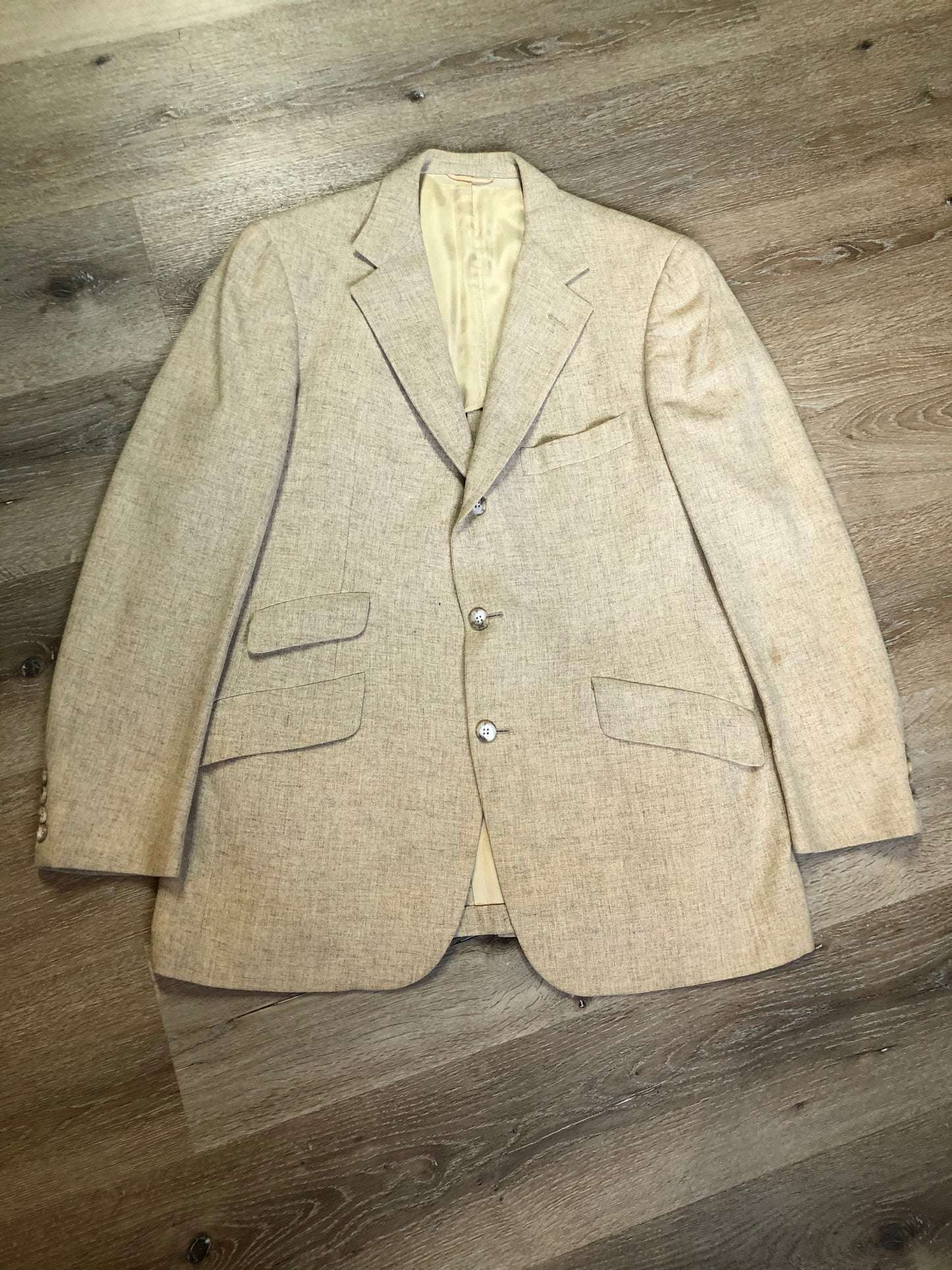Kingspier Vintage - Chaps by Ralph Lauren light beige two piece suit at Martini Carl Boston. Jacket is a three button notch lapel with three flap pockets and a breast pocket. The pants are flat front with two slash pockets, a tiny flap pocket in the front and two back pockets.