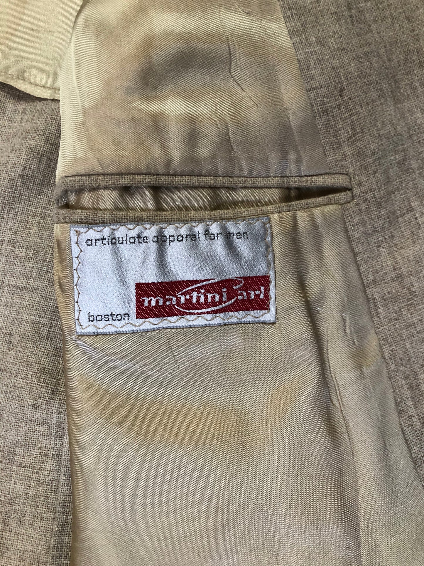 Kingspier Vintage - Chaps by Ralph Lauren light beige two piece suit at Martini Carl Boston. Jacket is a three button notch lapel with three flap pockets and a breast pocket. The pants are flat front with two slash pockets, a tiny flap pocket in the front and two back pockets.