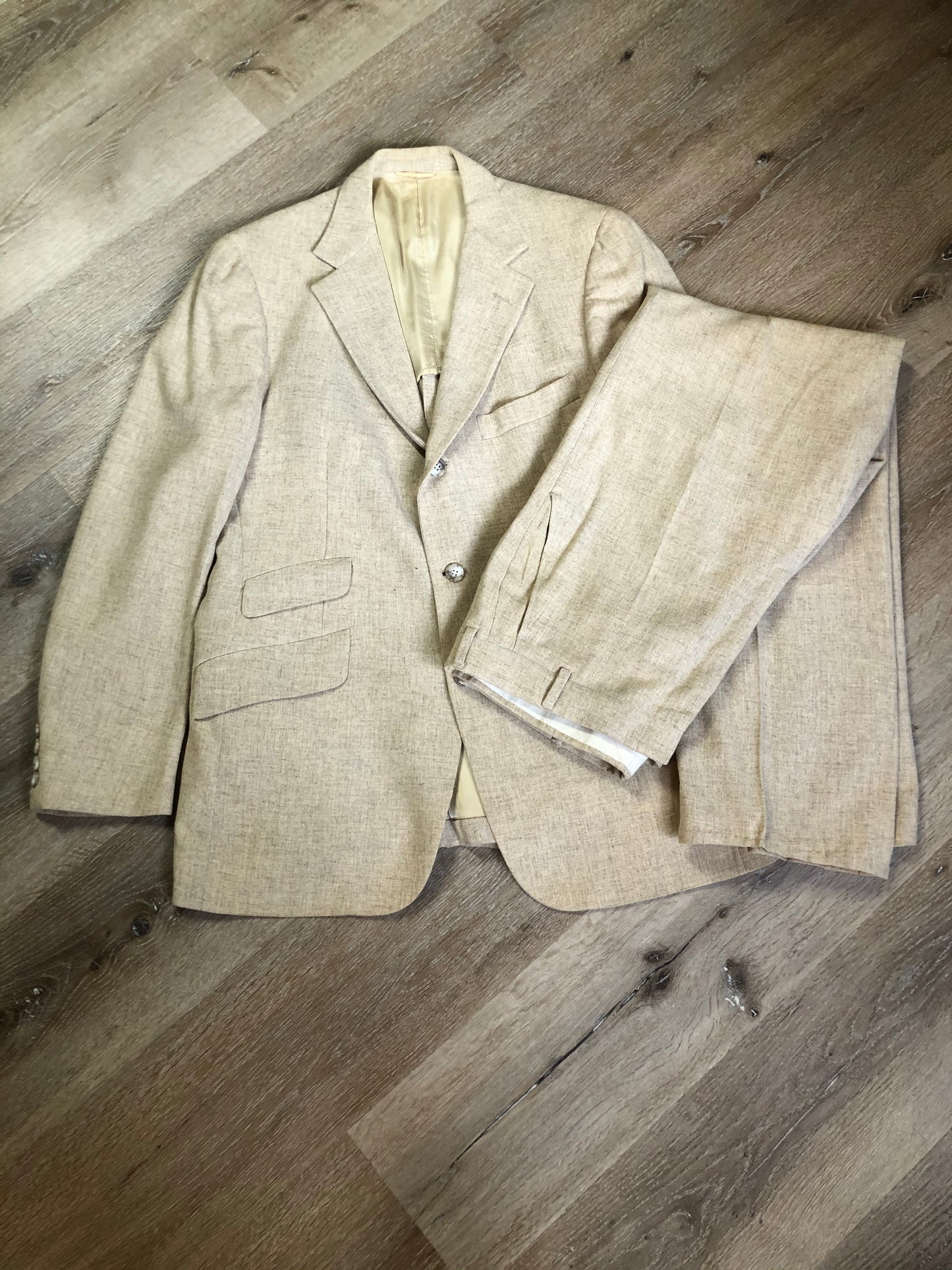 Kingspier Vintage - Chaps by Ralph Lauren light beige two piece suit at Martini Carl Boston. Jacket is a three button notch lapel with three flap pockets and a breast pocket. The pants are flat front with two slash pockets, a tiny flap pocket in the front and two back pockets.