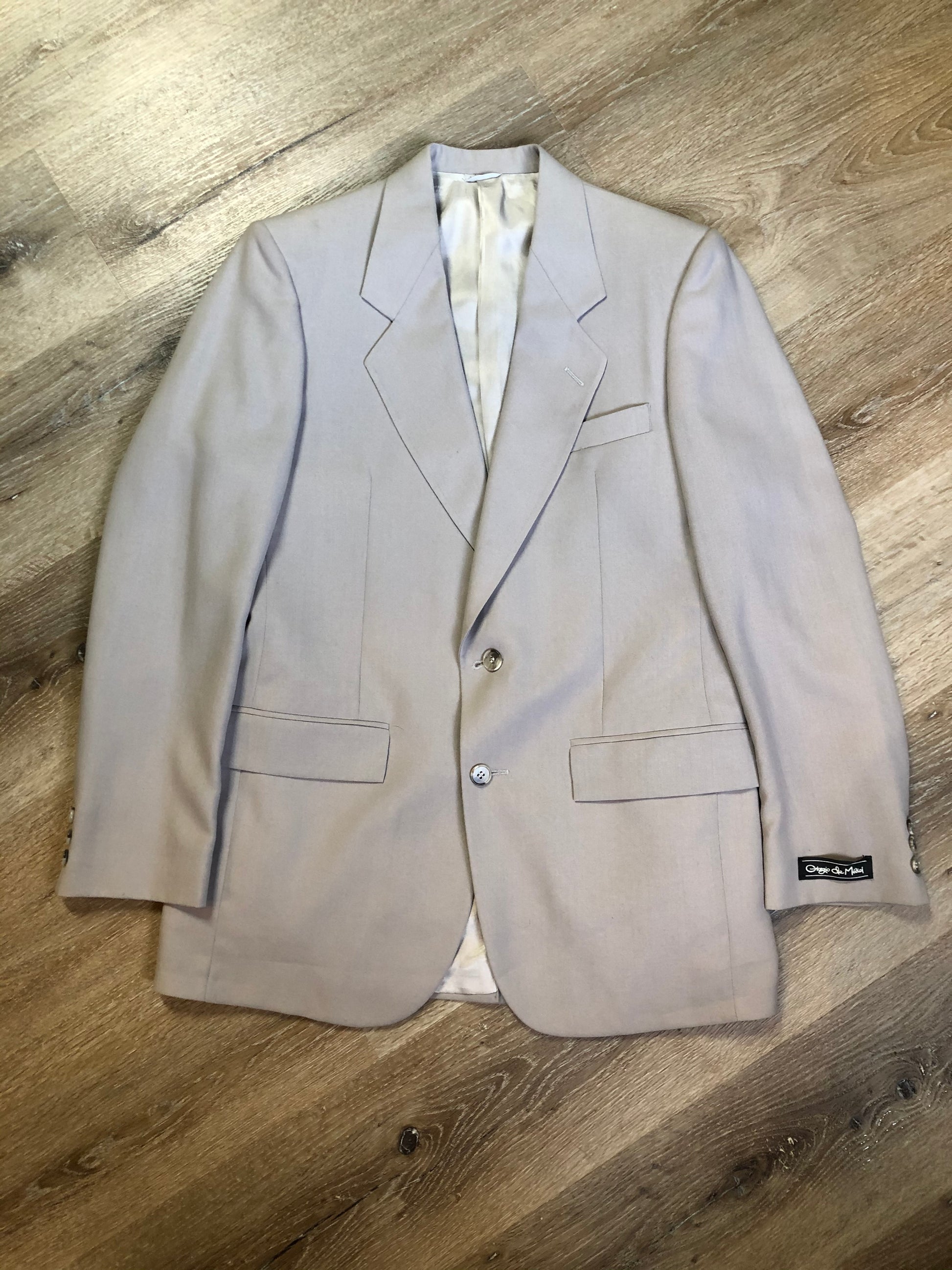 Kingspier Vintage - Georgio De Medici beige wool blend two piece suit,  at R.W. Phinney Ltd - Cornwallis Clothes in Kentville, NS. The jacket is a two button notch lapel with two flap pockets, a breast pocket and three inside pockets. The pants are pleated with two front slash pockets and two welt pockets in the back.