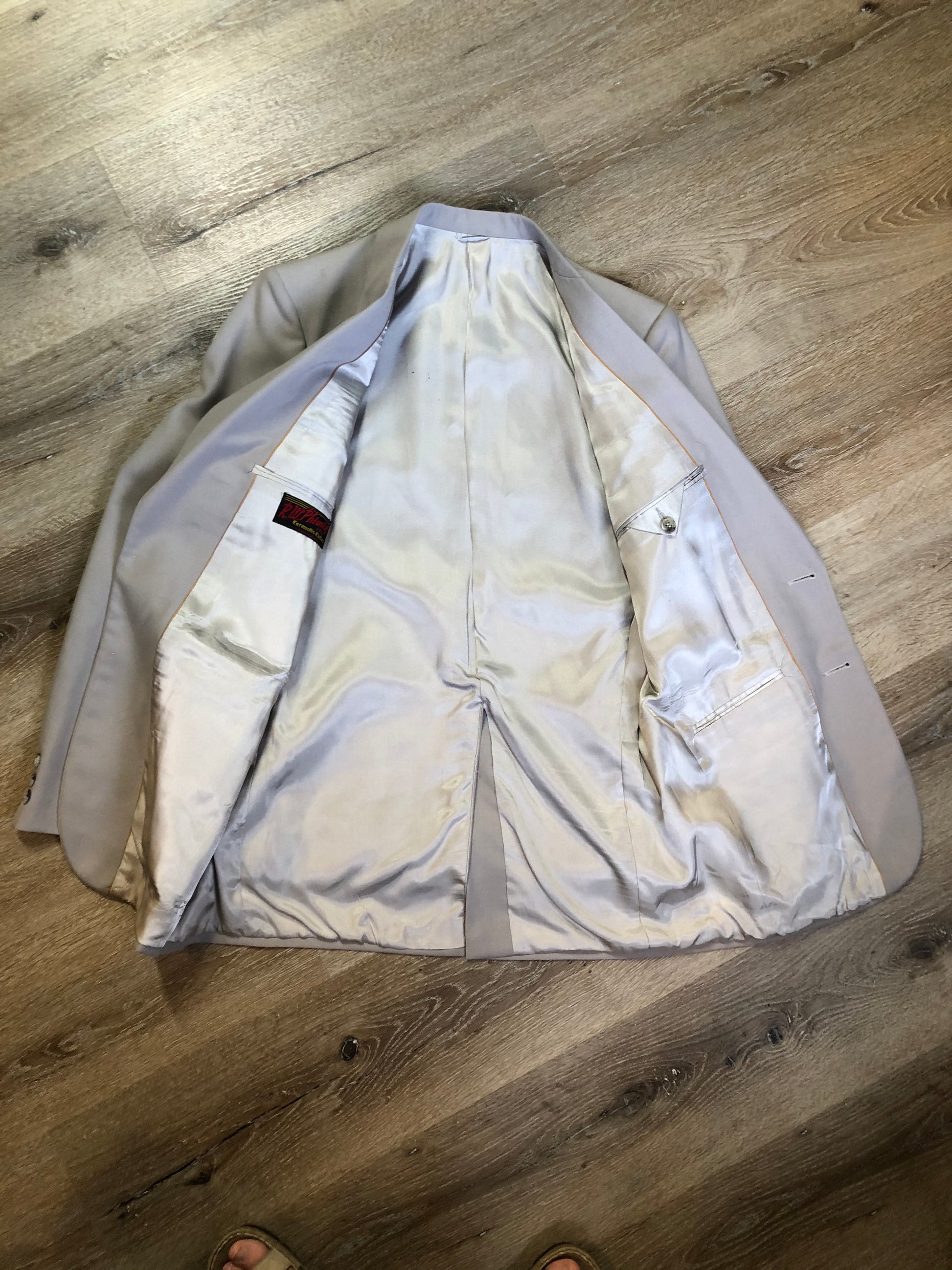 Kingspier Vintage - Georgio De Medici beige wool blend two piece suit,  at R.W. Phinney Ltd - Cornwallis Clothes in Kentville, NS. The jacket is a two button notch lapel with two flap pockets, a breast pocket and three inside pockets. The pants are pleated with two front slash pockets and two welt pockets in the back.