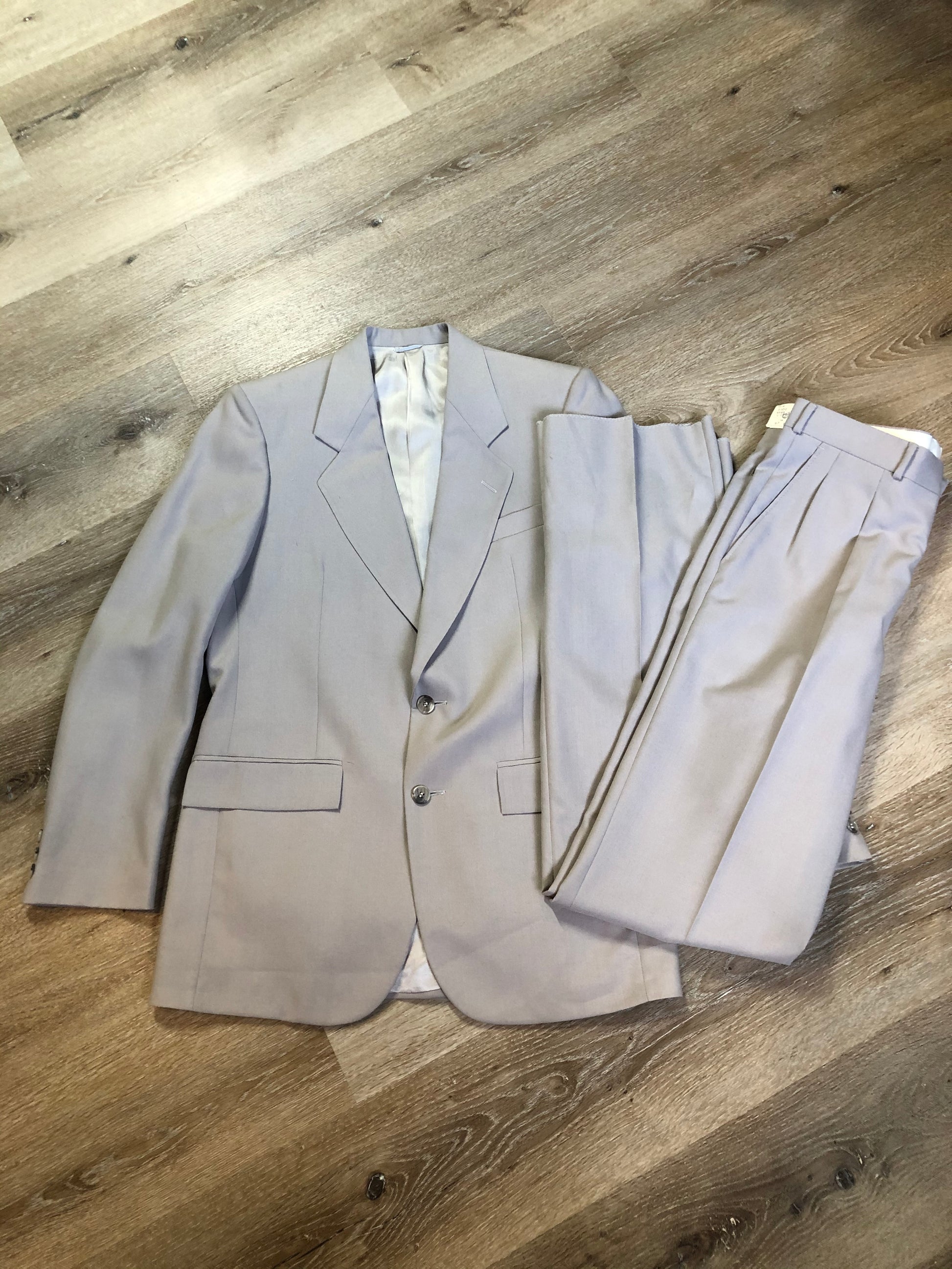 Kingspier Vintage - Georgio De Medici beige wool blend two piece suit,  at R.W. Phinney Ltd - Cornwallis Clothes in Kentville, NS. The jacket is a two button notch lapel with two flap pockets, a breast pocket and three inside pockets. The pants are pleated with two front slash pockets and two welt pockets in the back.