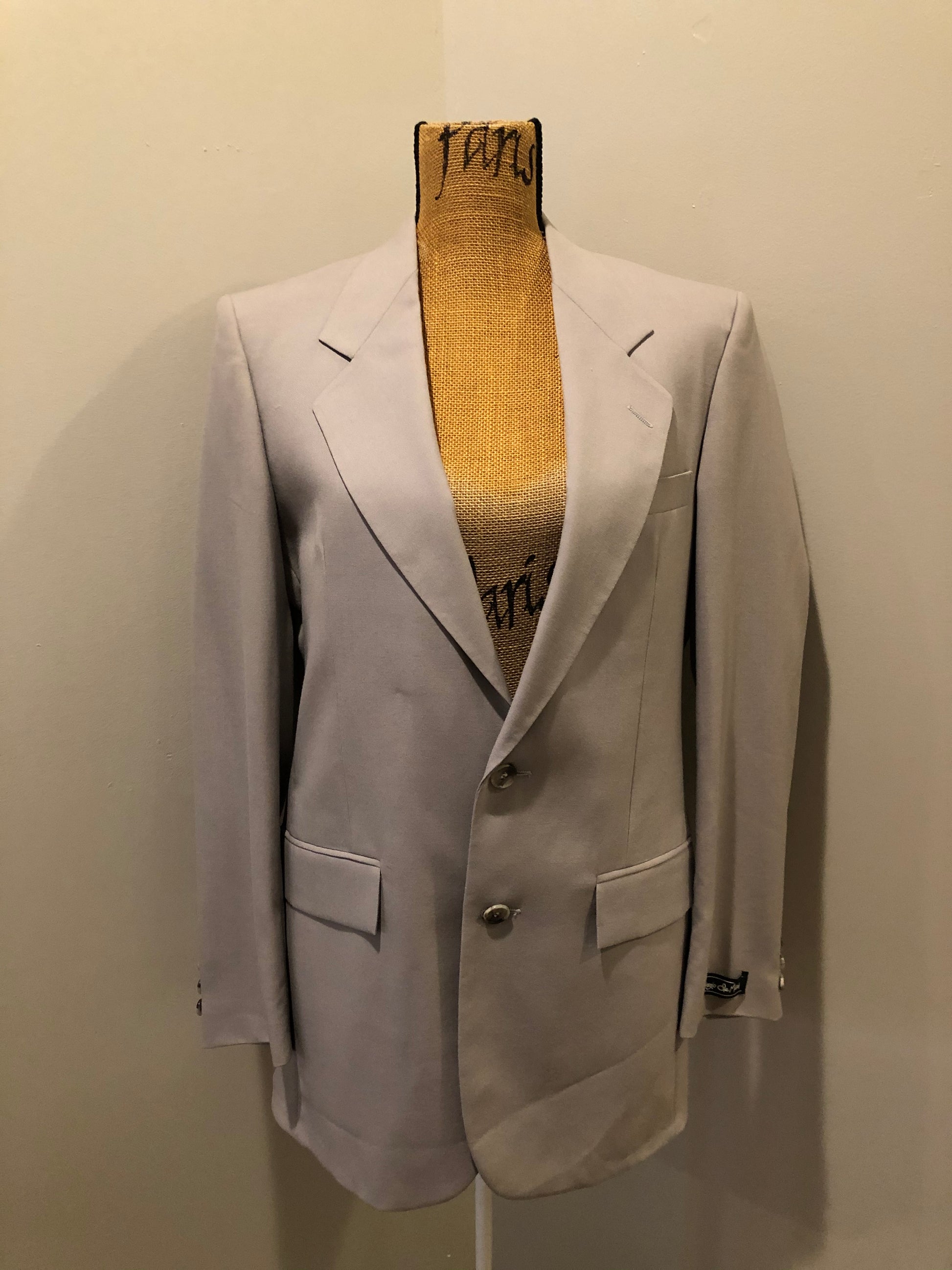 Kingspier Vintage - Georgio De Medici beige wool blend two piece suit,  at R.W. Phinney Ltd - Cornwallis Clothes in Kentville, NS. The jacket is a two button notch lapel with two flap pockets, a breast pocket and three inside pockets. The pants are pleated with two front slash pockets and two welt pockets in the back.